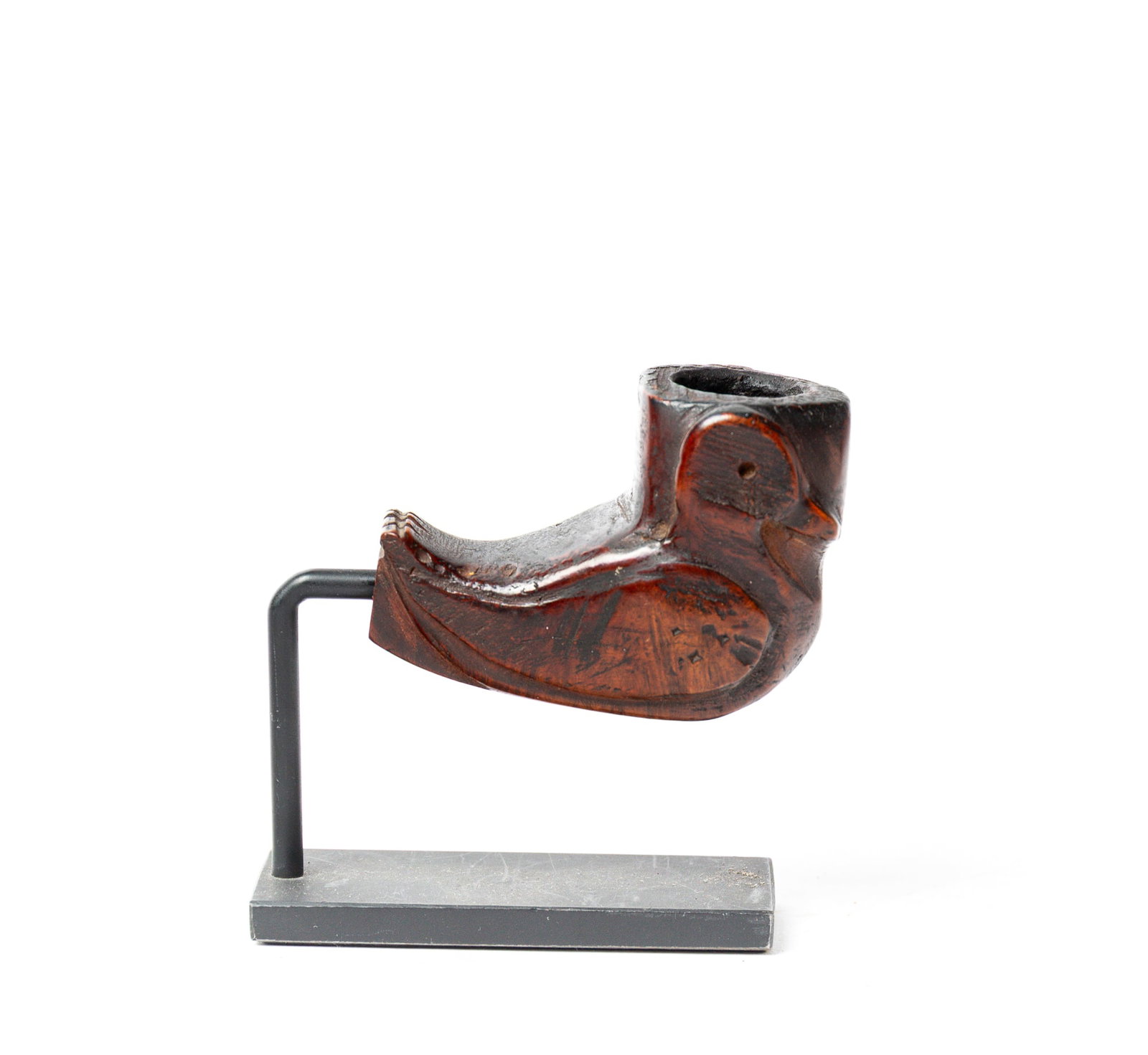 DUCK-FORM WOODEN EFFIGY PIPE.: DUCK-FORM WOODEN EFFIGY PIPE. Native American, 19th Century. Duck image carved on either side of bowl with , on a modern display stand. 2"h.