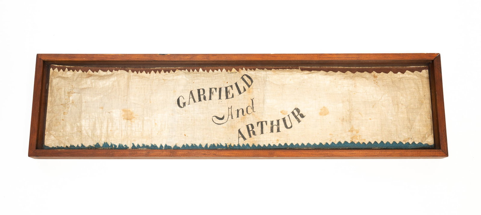 "GARFIELD AND ARTHUR" COTTON CAMPAIGN BANNER.: "GARFIELD AND ARTHUR" COTTON CAMPAIGN BANNER. American, late 19th Century. White cotton, black lettering and red and blue pinked trim. 10.5"h. 41.5"w. Provenance: From the Lifetime Collection of