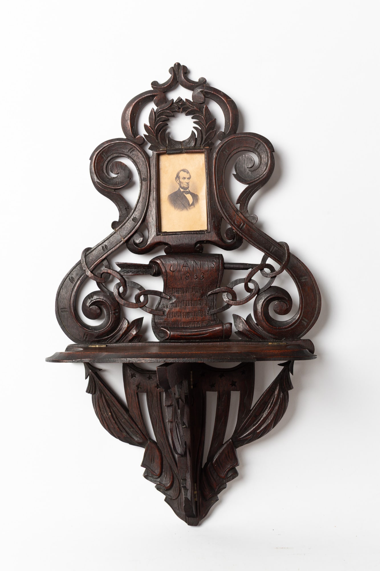 T.J. MAUJER (NEW YORK, NEW YORK) CARVED AND PIERCED PATRIOTIC WALNUT WALL SHELF HOUSING AN R.A. (1 of 4)