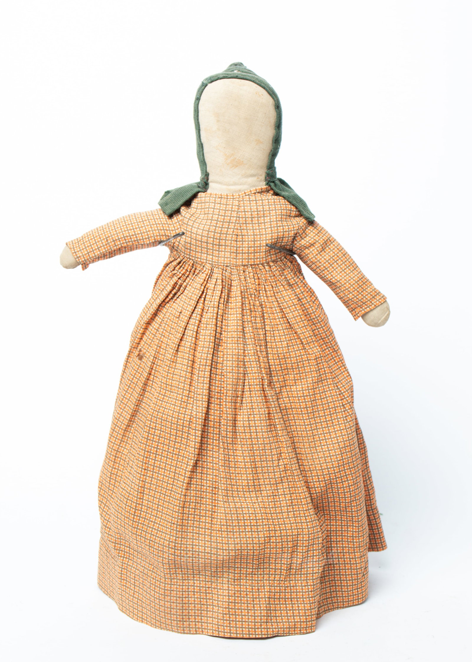 MENNONITE STUFFED CLOTH DOLL WITH GREEN BONNET.: MENNONITE STUFFED CLOTH DOLL WITH GREEN BONNET. American, late 19th or early 20th Century. Depicted with no face and wearing a wool cap and linen dress with bloomers. 20.5"h. Provenance: Nancy Goff