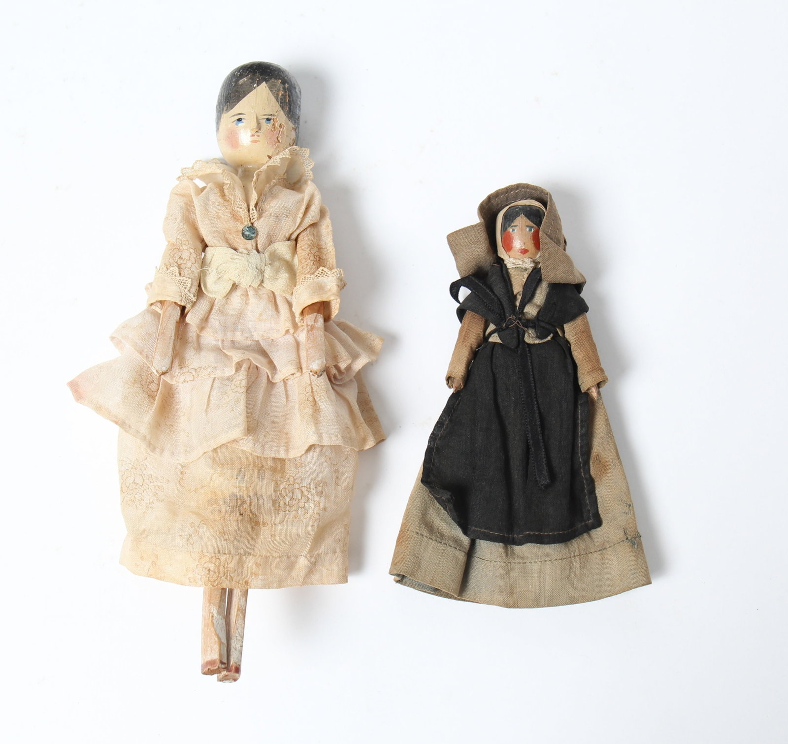 TWO WOOD PENNY DOLLS, INCL. GRODNERTAL PEGGED EXAMPLE.: TWO WOOD PENNY DOLLS, INCL. GRODNERTAL PEGGED EXAMPLE. German and possibly American, late 19th or early 20th Century. One Grodnertal doll with painted black hair and facial features with pink dress an