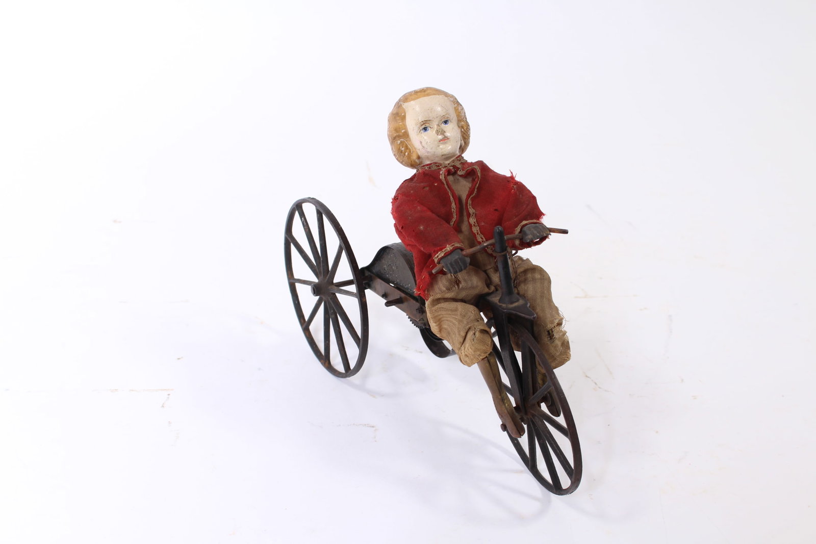 STEVENS & BROWN (CONNECTICUT) WINDUP CLOCKWORK VELOCIPEDE.: STEVENS & BROWN (CONNECTICUT) WINDUP CLOCKWORK VELOCIPEDE. American, 19th Century. Child with hand-painted composition head, wooden torso, brass hands and shoes, cloth outfit, and articulated wire leg