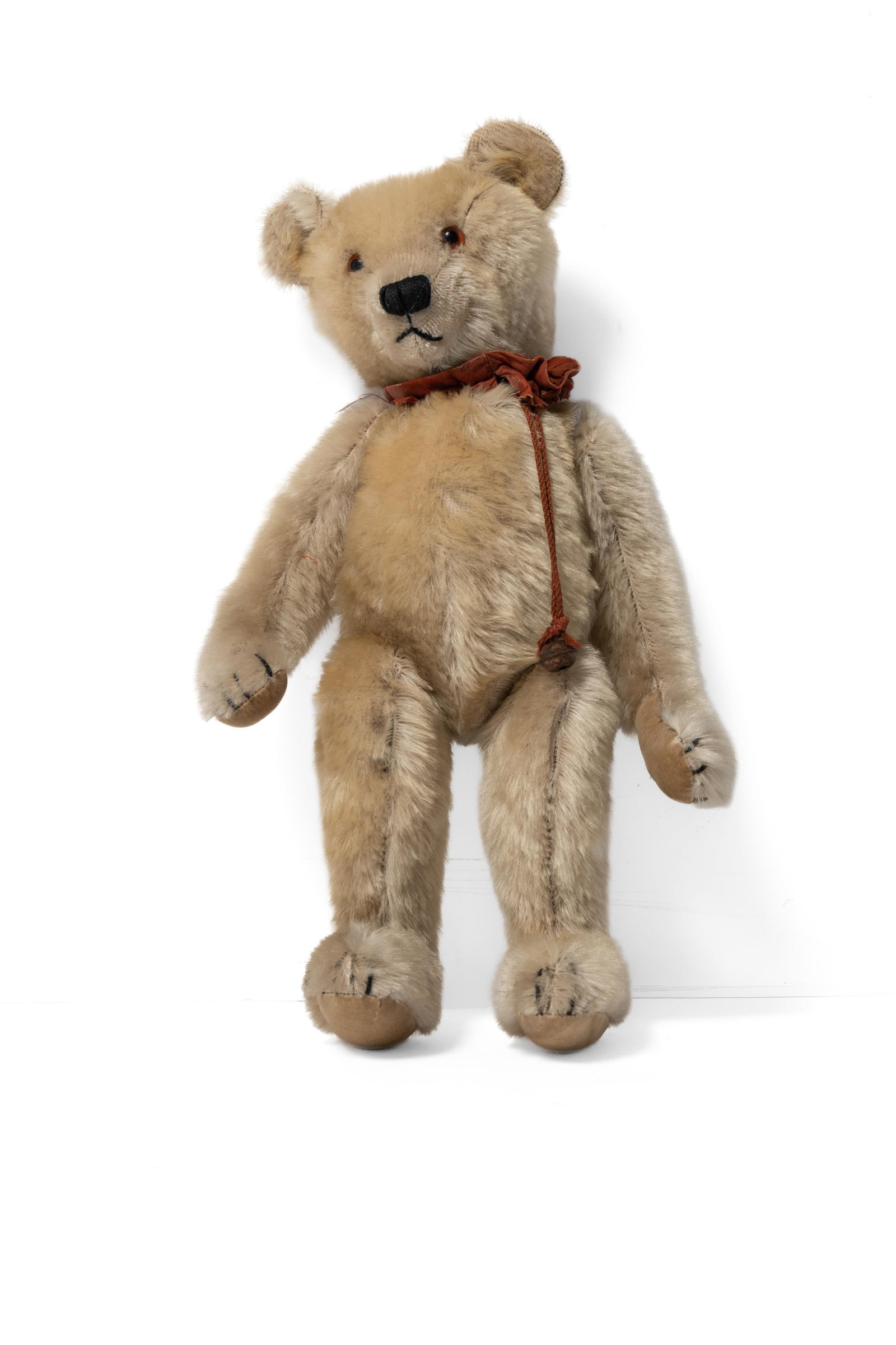 WHITE MOHAIR ARTICULATED TEDDY BEAR.: WHITE MOHAIR ARTICULATED TEDDY BEAR. German or American, early 20th Century. A white mohair articulated teddy bear, straw stuffed, with hump, original leather collar with bell, velvet pads on limbs,