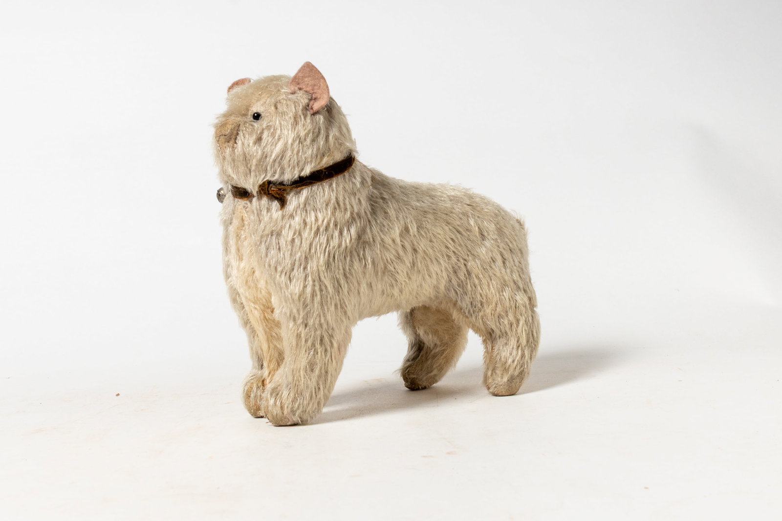 GERMAN STUFFED MOHAIR CAT TOY.: GERMAN STUFFED MOHAIR CAT TOY. Early 20th Century. A gray and white mohair cat with felt ears, black bead eyes, and a brown velvet collar with a bell. 9.5"h. Provenance: Nancy Goff (Alliance, Ohio).