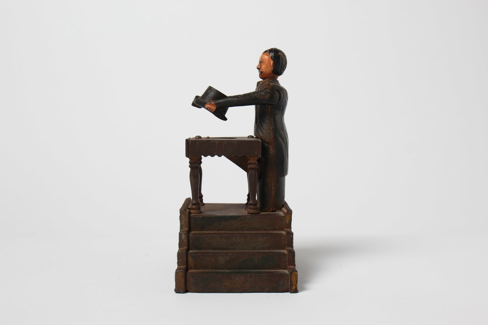 MAGICIAN CAST IRON MECHANICAL BANK BY J & E STEVENS. (1 of 8)