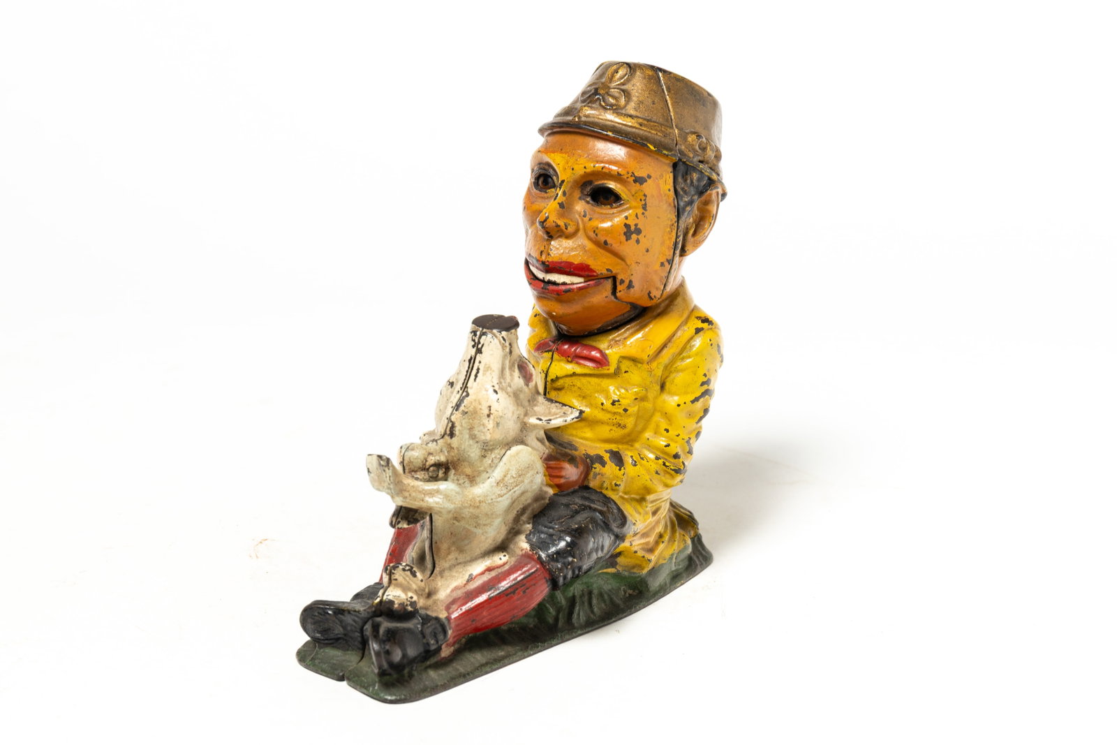 "PADDY AND THE PIG" PAINTED MECHANICAL COIN BANK.: "PADDY AND THE PIG" PAINTED MECHANICAL COIN BANK. American, 19th Century. Cast iron figural bank of a man holding a pig between his legs. When the coin goes in, he sticks his tongue out. 8"h. 7"l.