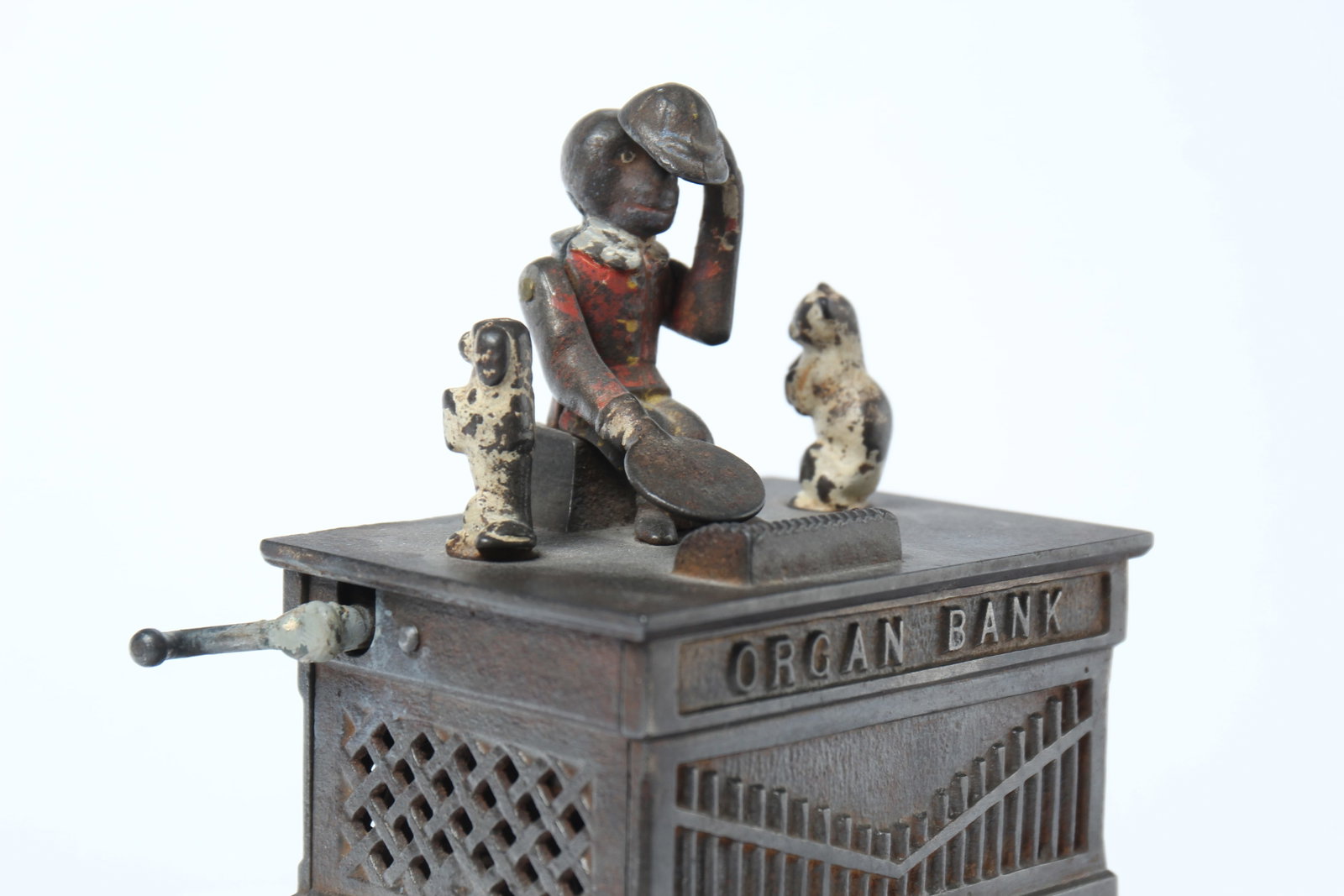 ORGAN CAST IRON MECHANICAL BANK BY KYSER & REX COMPANY.: ORGAN CAST IRON MECHANICAL BANK BY KYSER & REX COMPANY. American, late 19th Century. Three animals move atop a rectangular organ as arm is cranked. 7.5"h. 5.75"l. 4"d.