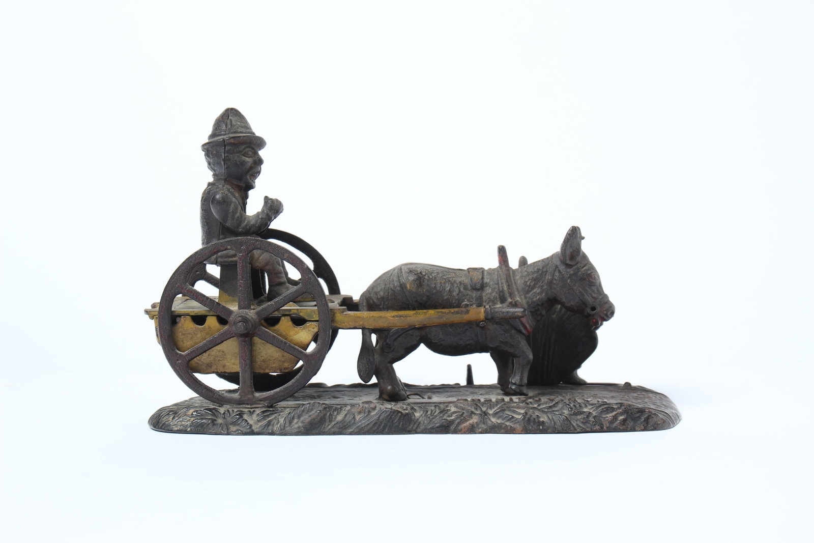 BAD ACCIDENT CAST IRON MECHANICAL BANK BY J & E STEVENS.: BAD ACCIDENT CAST IRON MECHANICAL BANK BY J & E STEVENS. American, late 19th Century. Depicts a man on a mule-drawn carriage and a boy hiding behind foliage. 6.25"h. 10"l. 3.5"d.