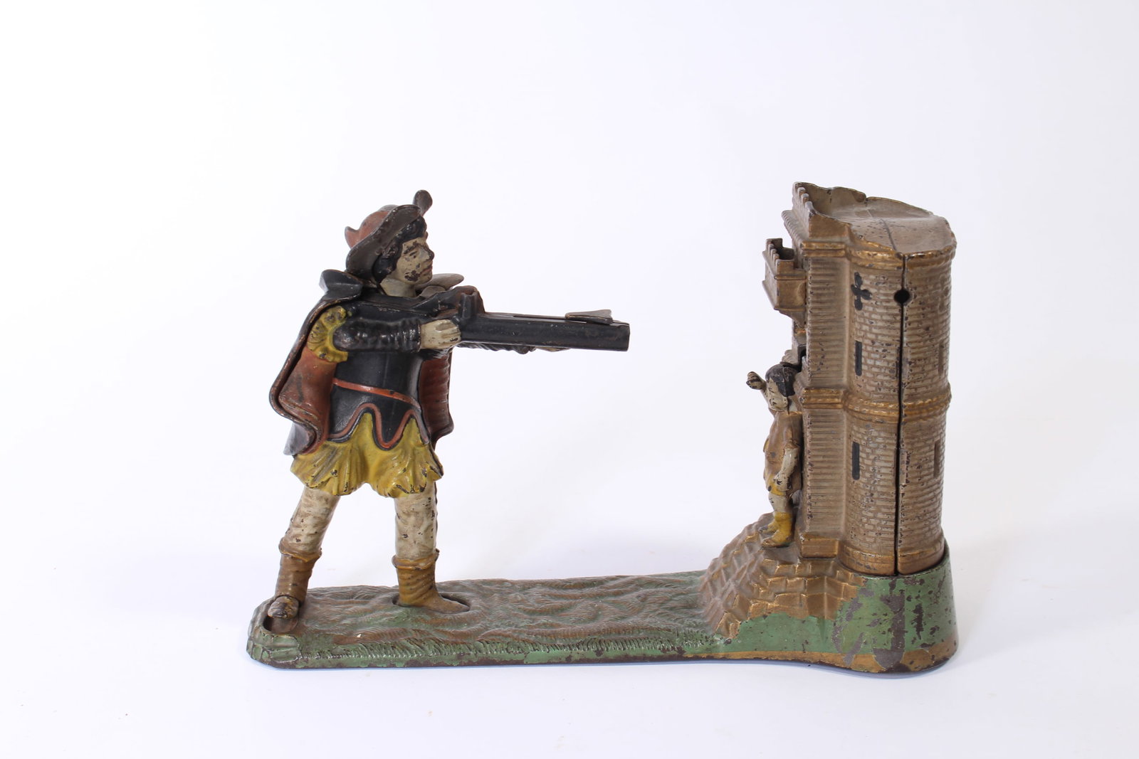 WILLIAM TELL CAST IRON MECHANICAL BANK BY J & E STEVENS.: WILLIAM TELL CAST IRON MECHANICAL BANK BY J & E STEVENS. American, late 19th Century. Depicts a man with a rifle aiming at a boy standing in front of a castle. 6.75"h. 10"l. 3.75"d.