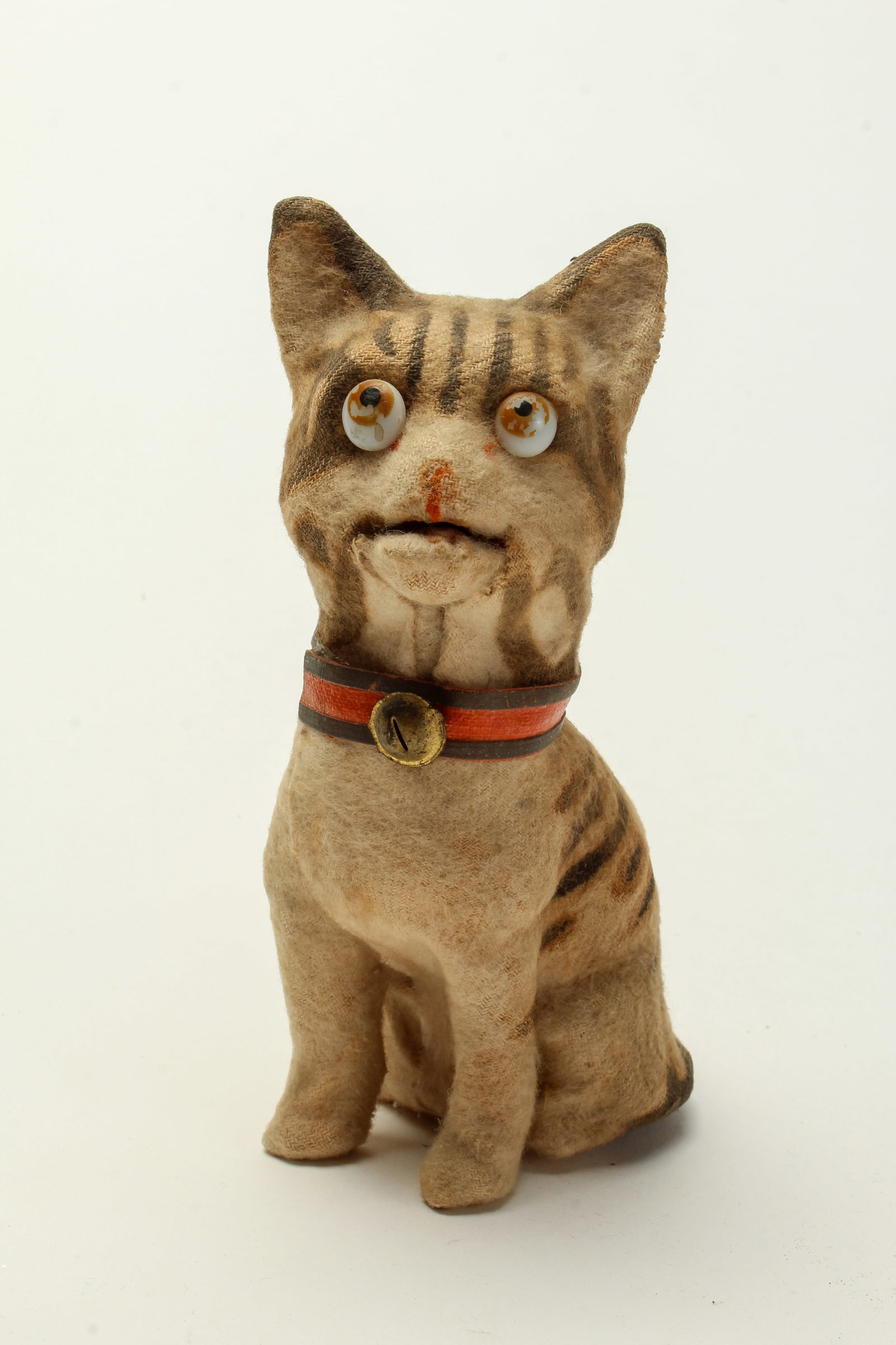 SQUEAKING CAT TOY.: SQUEAKING CAT TOY. American, early 20th Century. Composition body covered with felt in light brown with dark stripes, milk glass eyes looking up, a red and black collar with a brass bell, and when