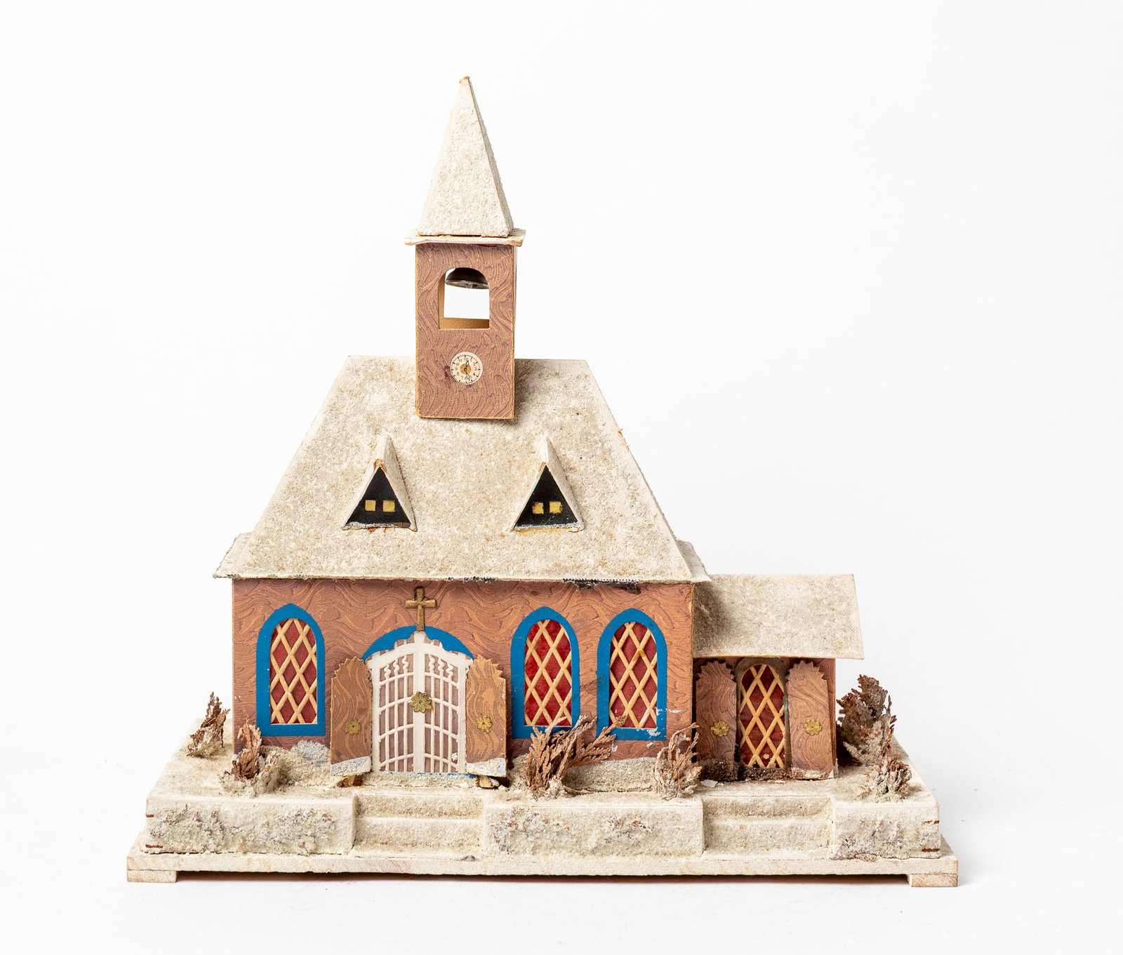 GERMAN PRESSED CARDBOARD CHURCH.: GERMAN PRESSED CARDBOARD CHURCH. Germany, early 20th Century. A church mounted on a board, front doors do not open, mica decorated roof, steeple, base, lattice window, two in front with gables,