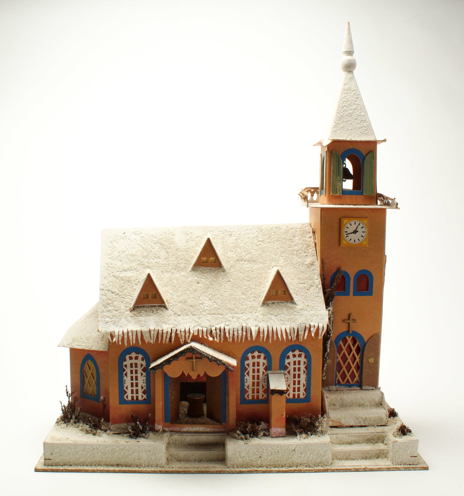 LARGE FOLKSY CHURCH MODEL.: LARGE FOLKSY CHURCH MODEL. Germany, 20th Century. Cardboard. Details include gables, steps, mica on roof, and lattice on windows; clock on steeple; spire with brass bell; interior with crucifix;