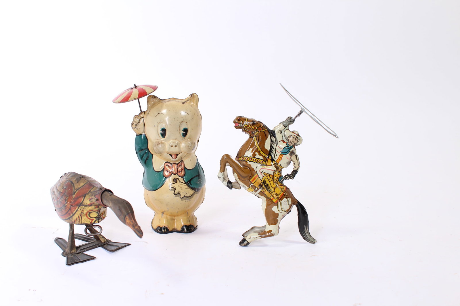 LOUIS MARX (NEW YORK, NEW YORK) TIN LITHO WINDUP PORKY PIG, GOLDEN GOOSE, AND COWBOY RIDER. (1 of 12)