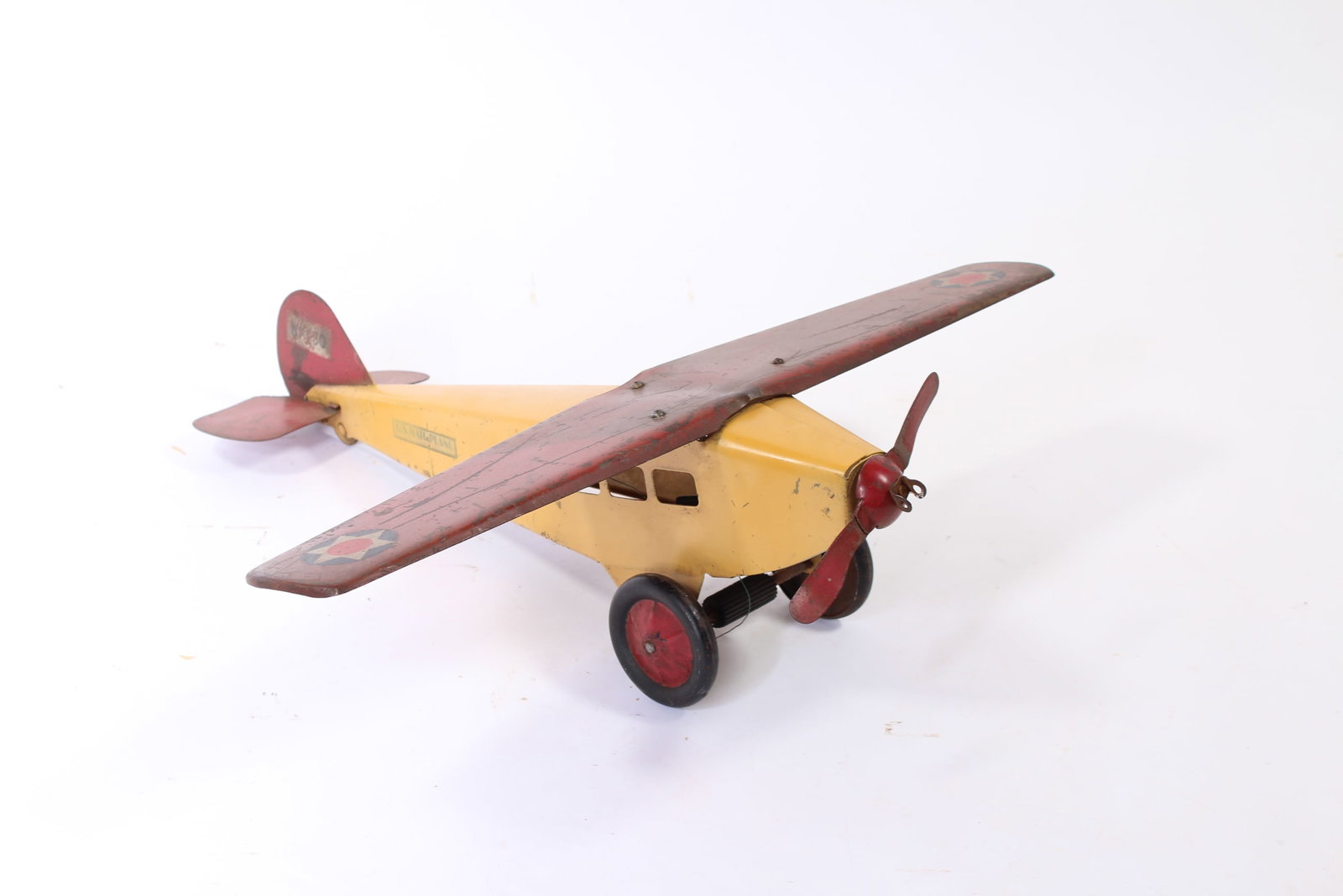 STEELCRAFT (CLEVELAND, OHIO) PRESSED STEEL FRICTION NX130 U.S. MAIL PLANE.: STEELCRAFT (CLEVELAND, OHIO) PRESSED STEEL FRICTION NX130 U.S. MAIL PLANE. American, 20th Century. Red and yellow plane with single propeller, star decals on wings, "NX130" on decals on tail, and
