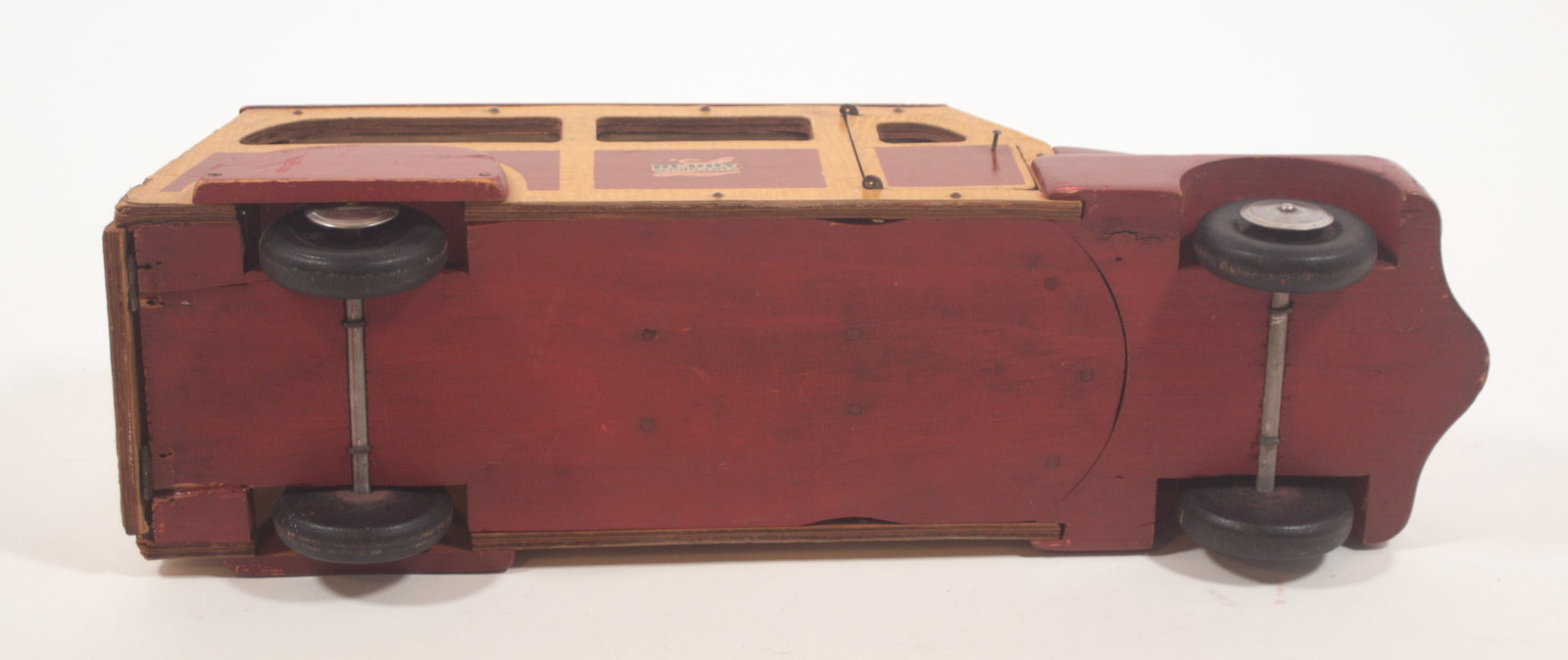 BUDDY L (EAST MOLINE, ILLINOIS) WOODEN STATION WAGON.: BUDDY L (EAST MOLINE, ILLINOIS) WOODEN STATION WAGON. American, 20th Century. Red and grain-painted laminated wood wagon with clear plastic windows, opening front doors and rear door, chrome headlight