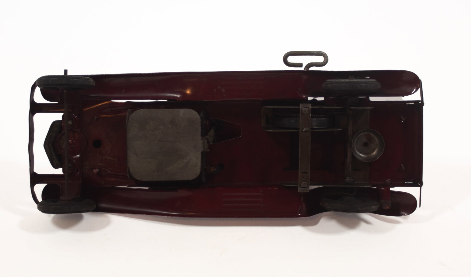 GIRARD (PENNSYLVANIA) PRESSED STEEL WINDUP DELUXE PIERCE ARROW COUPE.: GIRARD (PENNSYLVANIA) PRESSED STEEL WINDUP DELUXE PIERCE ARROW COUPE. American, 20th Century. In pink and burgundy, with two electric headlights and a rear light, two spare tires on either side, and s