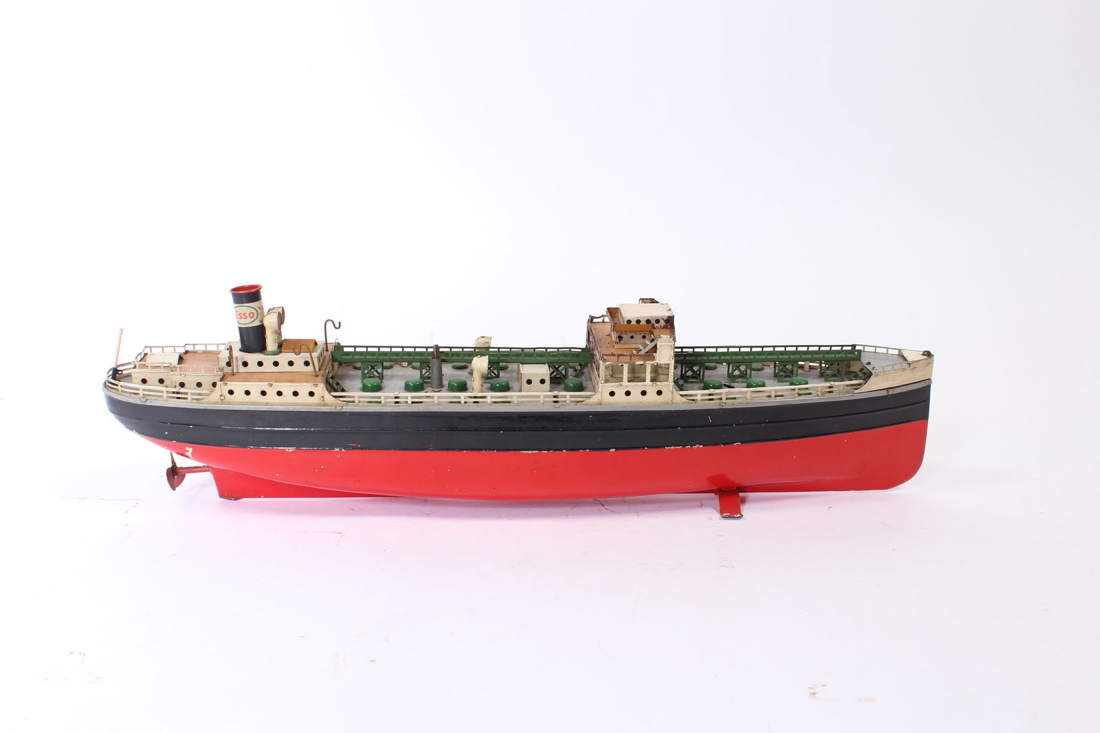 FLEISCHMANN ESSO OIL TANKER TOY.: FLEISCHMANN ESSO OIL TANKER TOY. American, 20th Century. Painted tin. Detailed deck with the Esso logo painted on black smokestack, red and black hull with the Fleischman logo in gold, red propeller,