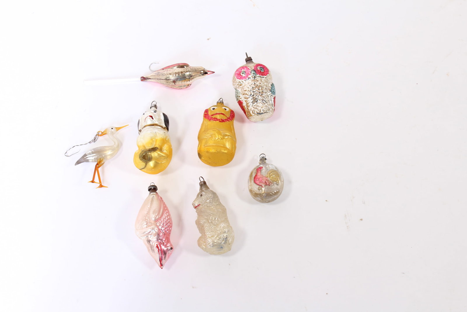 EIGHT EARLY GLASS ANIMAL THEMED CHRISTMAS ORNAMENTS.: EIGHT EARLY GLASS ANIMAL THEMED CHRISTMAS ORNAMENTS. Germany, early 20th Century. Including a lion, dogs, a monkey, an owl, birds, a frog and a bird with a spun glass tail. Largest, 3.5"h. Provenance: