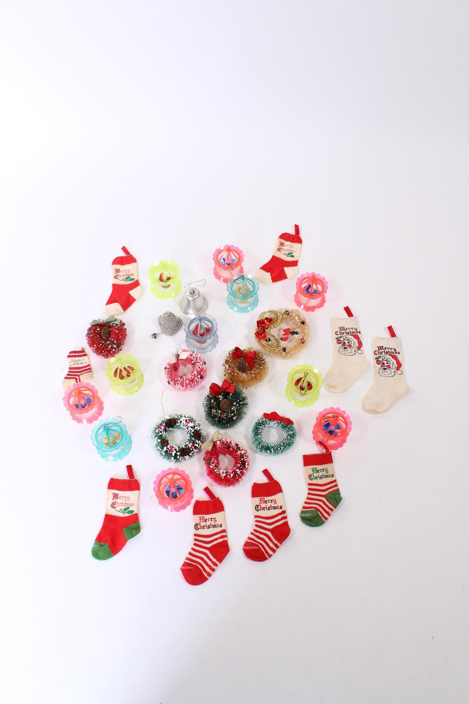 GROUP OF CHRISTMAS TREE ORNAMENTS AND DECORATIONS.: GROUP OF CHRISTMAS TREE ORNAMENTS AND DECORATIONS. America and Germany, 20th Century. Includes decorated bottle brush wreaths, birdcage spinners, and miniature stockings. Largest, 7"l. Provenance:
