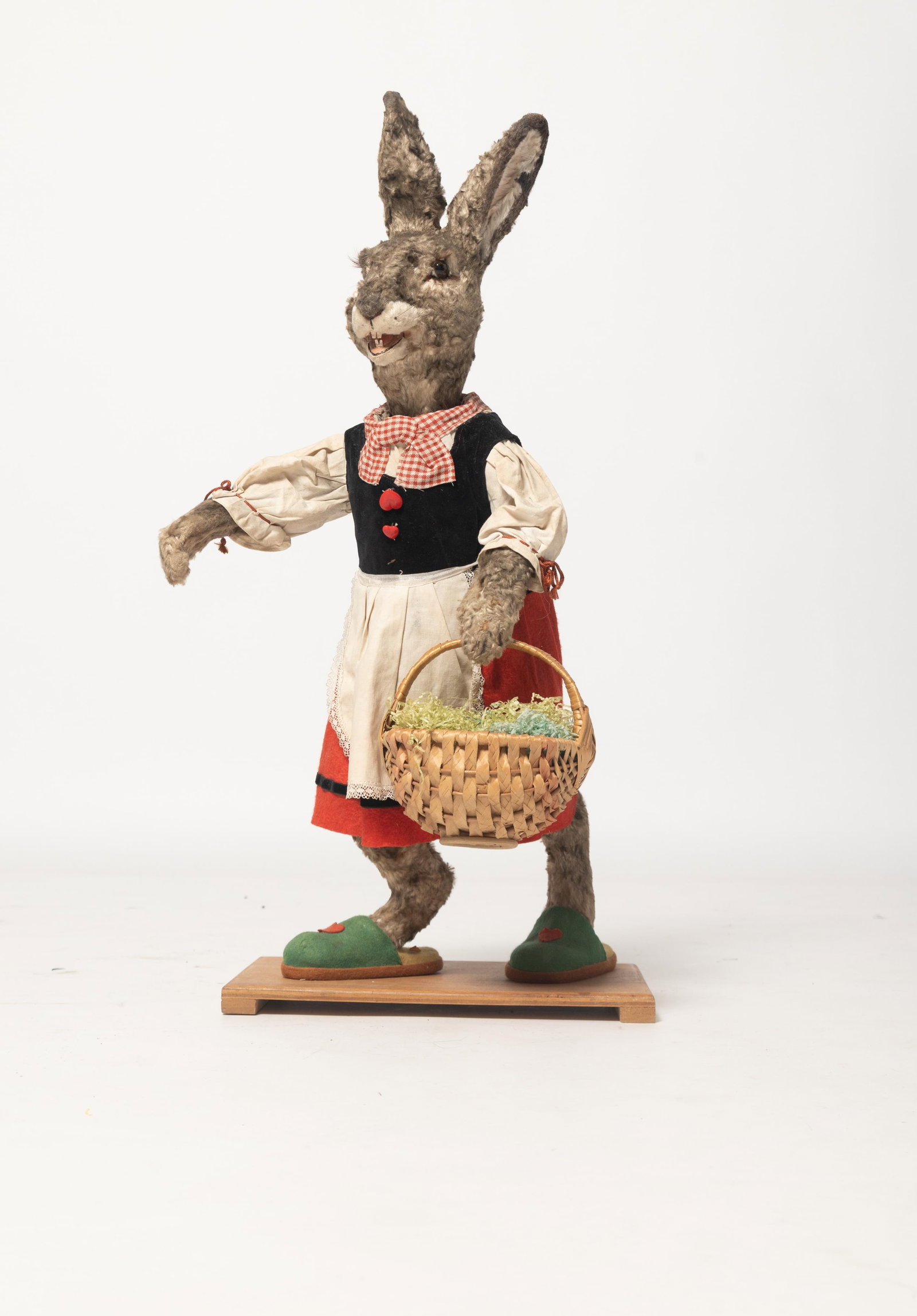 LARGE CLOCKWORK RABBIT LADY ON BASE.: LARGE CLOCKWORK RABBIT LADY ON BASE. Germany, early 20th Century. Large standing rabbit figure with a fur-covered body, glass eyes, long eyelashes, articulated mouth, wearing a black velvet vest with