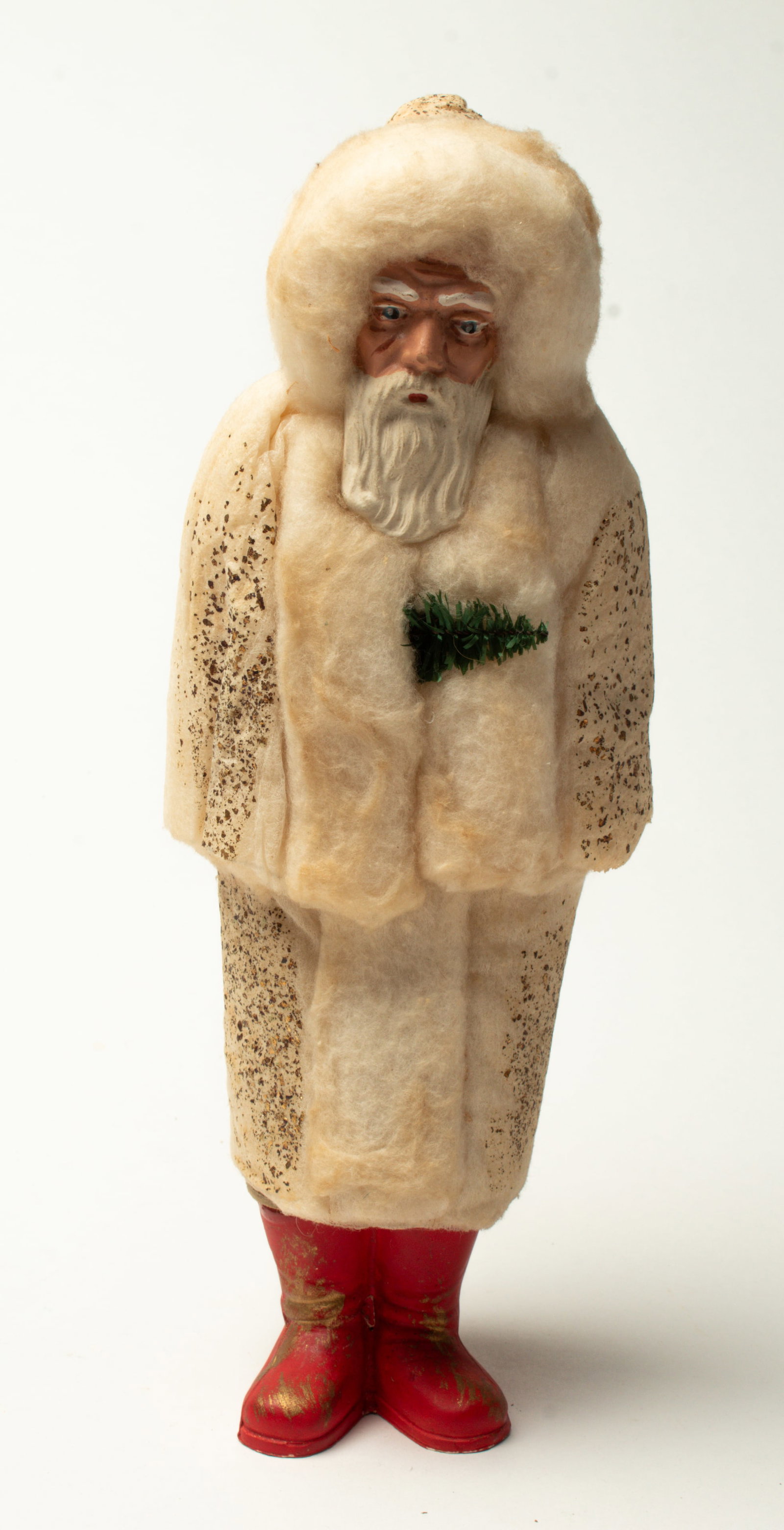 COTTON COAT SANTA CANDY CONTAINER.: COTTON COAT SANTA CANDY CONTAINER. France, early 20th Century. Standing Santa wearing a white cotton batting coat with gold flakes, holding a tree sprig, with a painted composition face, and wearing