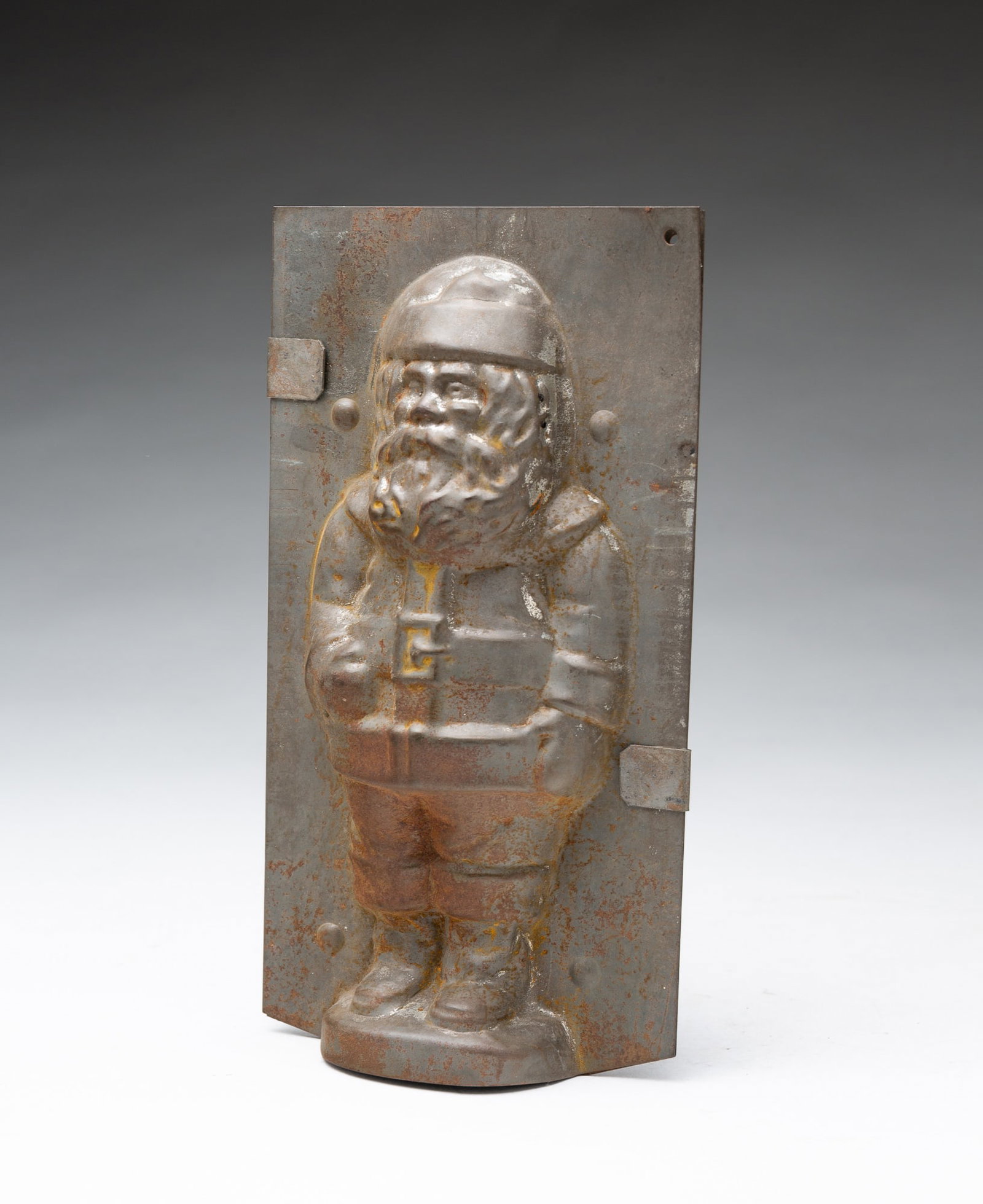 TIN SANTA CLAUS CHOCOLATE MOLD.: TIN SANTA CLAUS CHOCOLATE MOLD. American, early 20th Century. Standing Santa in traditional attire. 7.25"h. 4"w. 2"d.