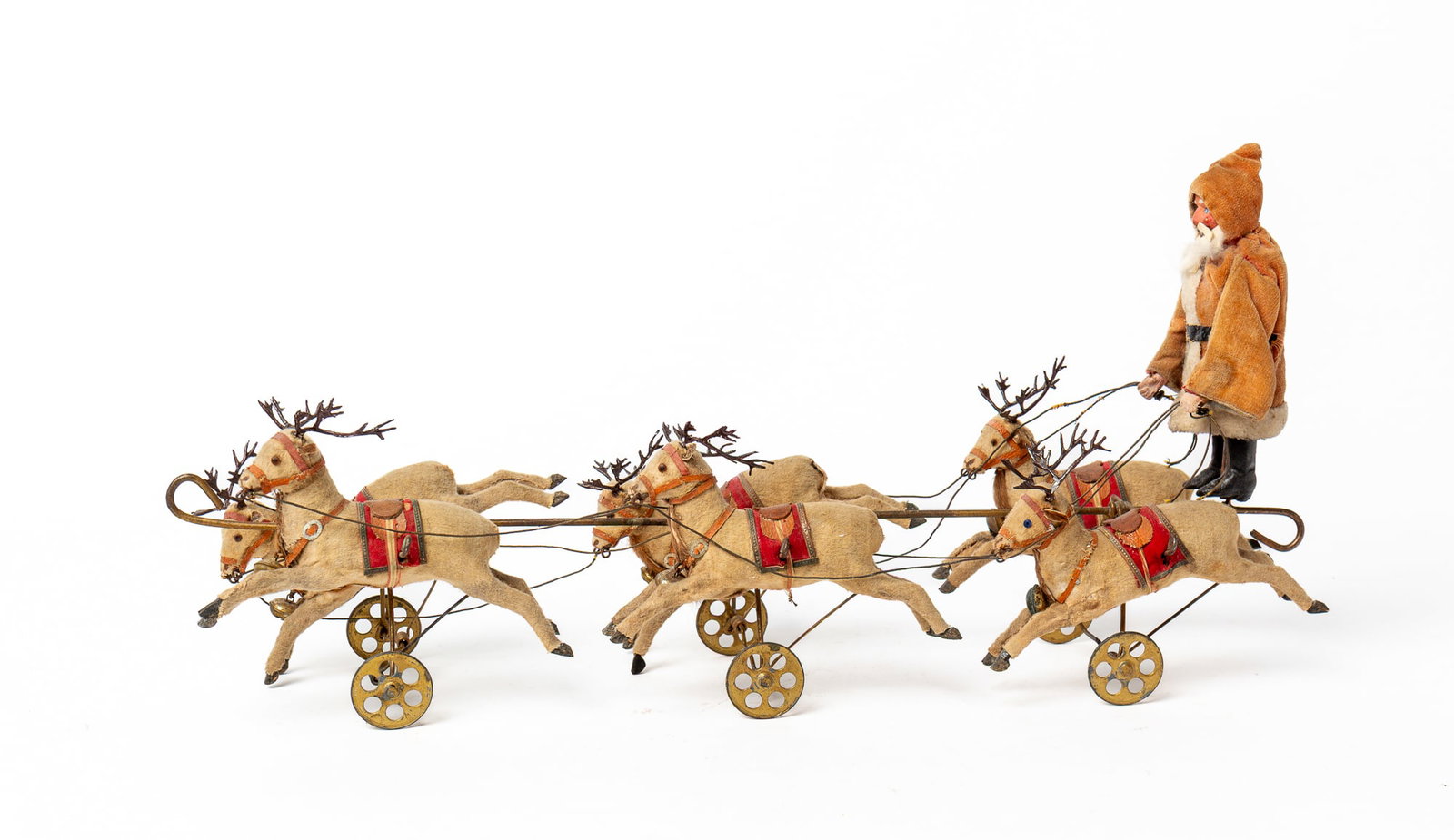 SANTA'S SLEIGH DRAWN BY SIX FLYING REINDEER.: SANTA'S SLEIGH DRAWN BY SIX FLYING REINDEER. Germany, early 20th Century. Santa standing, wearing a red velvet coat with white trim, a black belt, and boots, with a rabbit fur beard, and holding reins