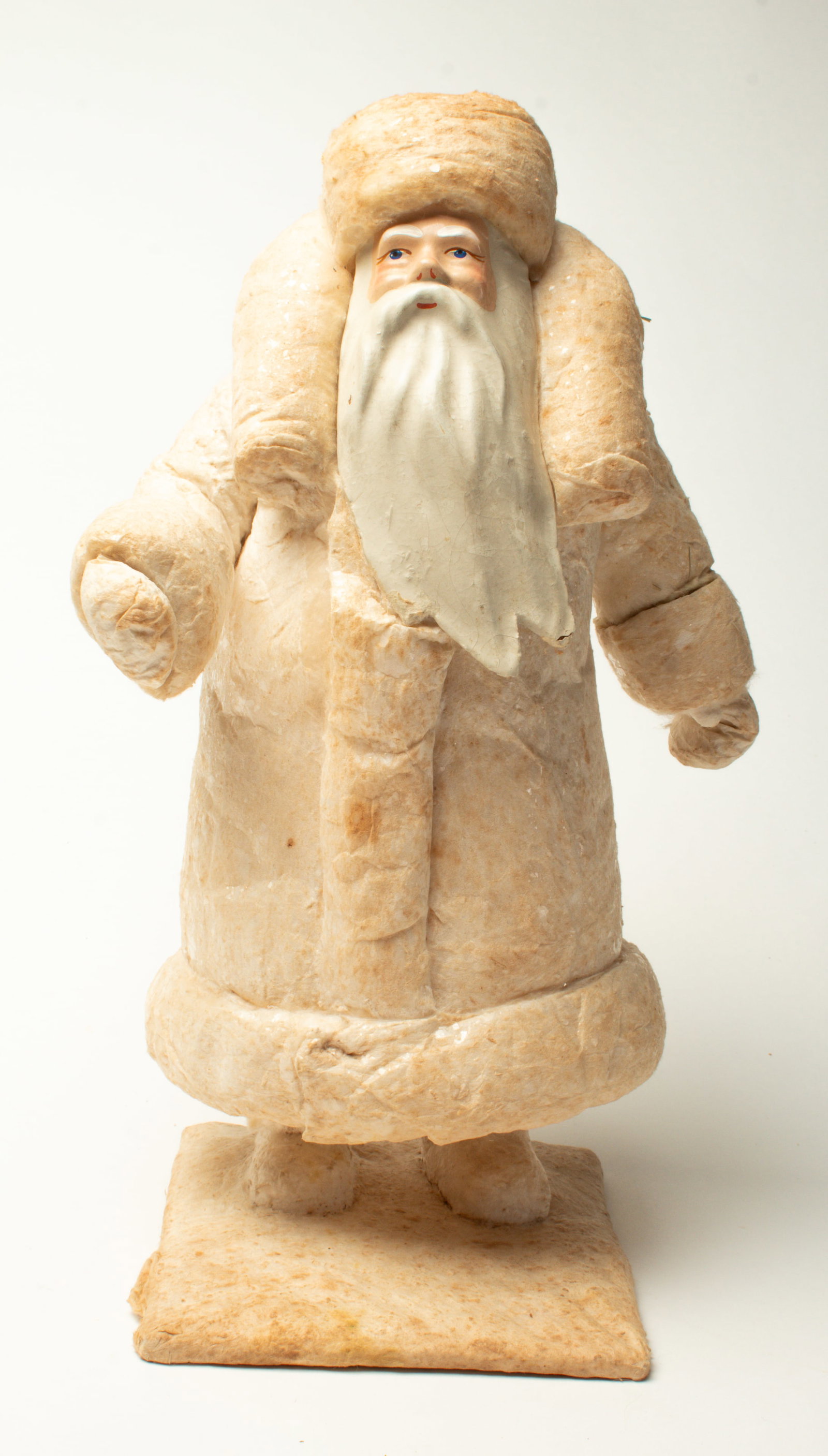 LARGE COTTON COAT STANDING SANTA FIGURE.: LARGE COTTON COAT STANDING SANTA FIGURE. Russian, early 20th Century. A standing Santa wearing a puffy, long cotton coat, mittens, and hat with mica flakes, a composition face with a long beard and