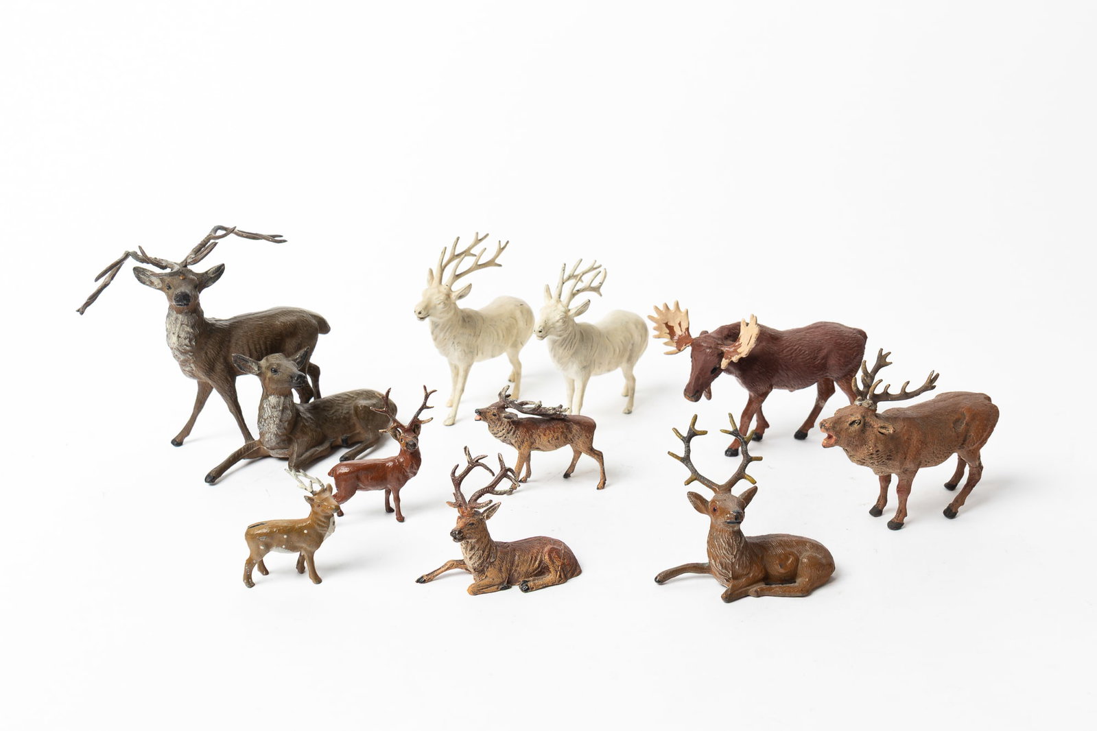 GROUP OF TEN PUTZ REINDEER AND A MOOSE.: GROUP OF TEN PUTZ REINDEER AND A MOOSE. Germany and Japan, early 20th Century. Comprising cold-painted and composition examples, some marked on the underside. Largest, 5.5"h.
