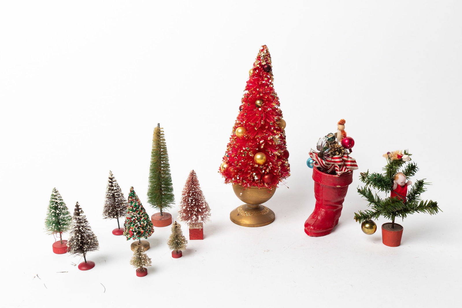 GROUP OF ELEVEN CHRISTMAS BOTTLE BRUSH TREES.: GROUP OF ELEVEN CHRISTMAS BOTTLE BRUSH TREES. Japanese and American, early 20th Century. Comprising trees of various sizes and colors, one potted with decorations and one in with decorations in a