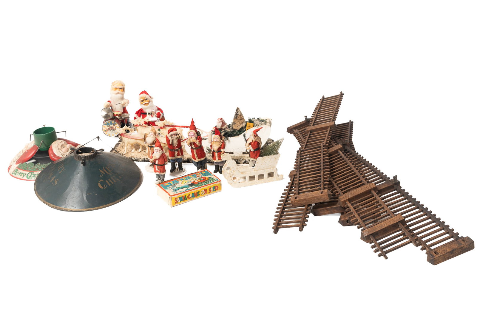 COLLECTION OF CHRISTMAS DECORATIONS.: COLLECTION OF CHRISTMAS DECORATIONS. American and Japanese, 20th Century. A composition Santa figure nestled in his sleigh with snow-covered trees, being pulled by four celluloid reindeer mounted to