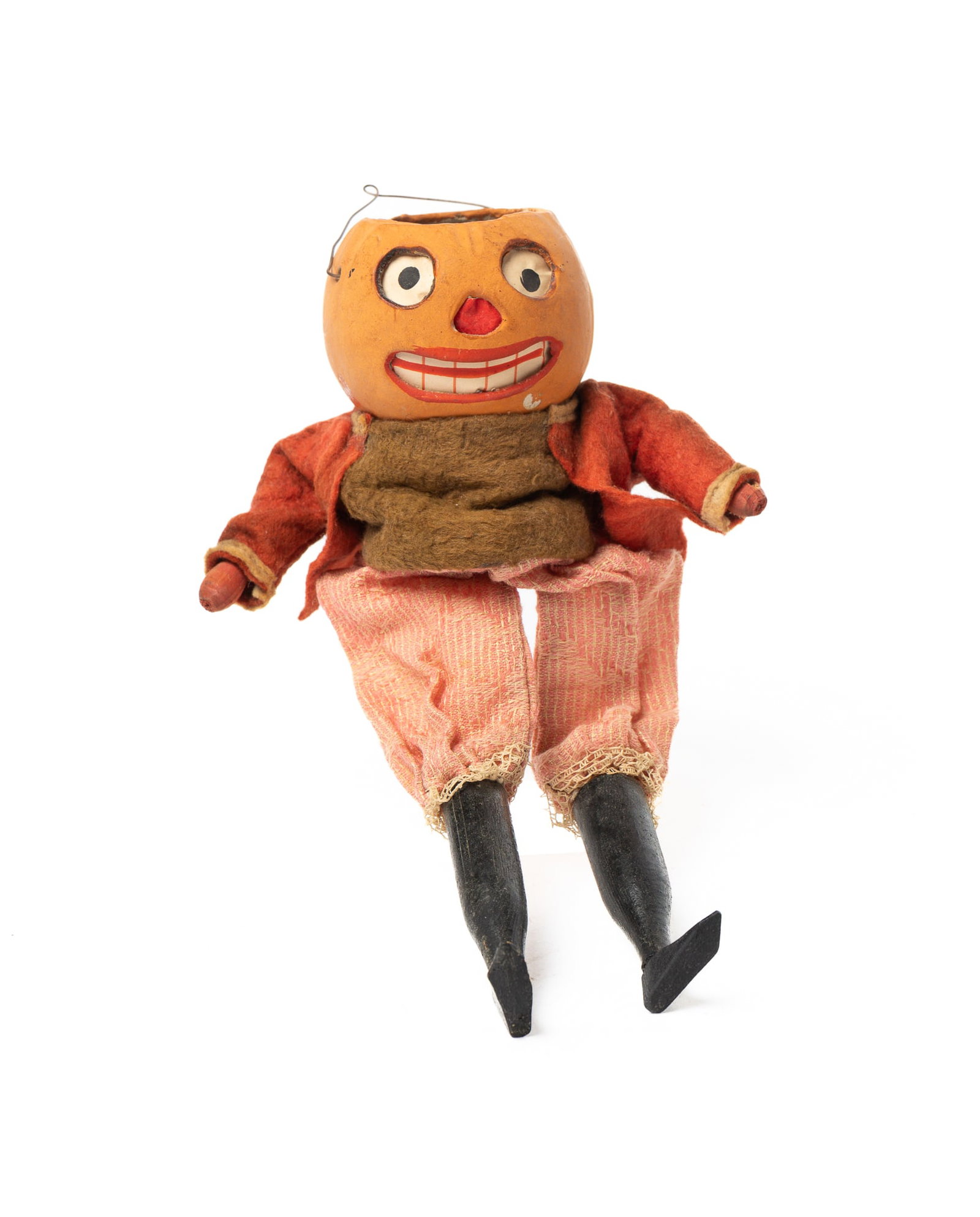 PUMPKIN MAN JACK-O-LANTERN.: PUMPKIN MAN JACK-O-LANTERN. Germany, early 20th Century. A hanging jack-o-lantern head squeaker with wooden arms and legs, wearing a red felt coat, green felt shirt, red pants with lace, original