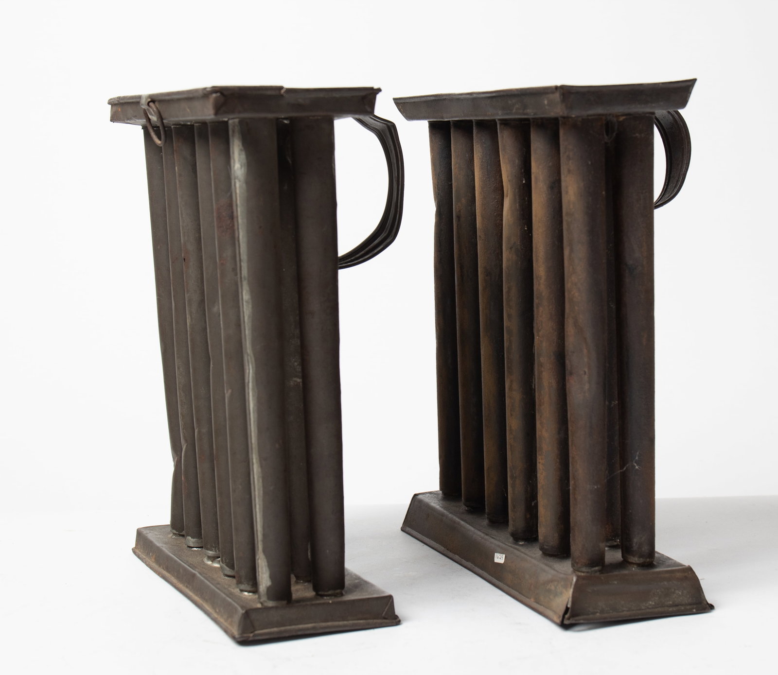 TWO PENNSYLVANIA TIN CANDLE MOLDS, SIGNED "E.P. BARRETT" AND "S. IHLING".: TWO PENNSYLVANIA TIN CANDLE MOLDS, SIGNED "E.P. BARRETT" AND "S. IHLING". American, 19th Century. Twelve-candle mold with handle, marked "E.P. Barrett / Maker / Williamsport PA" on plate at handle