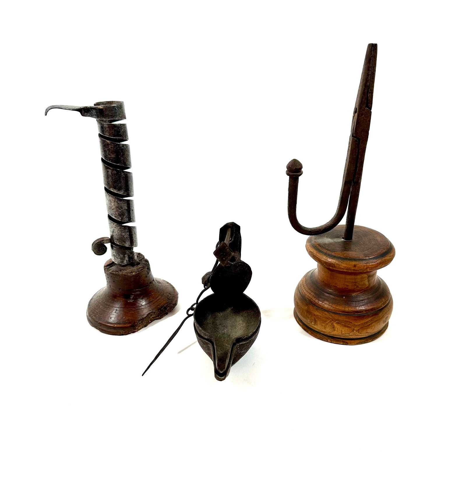 THREE EARLY LIGHTING ITEMS.: THREE EARLY LIGHTING ITEMS. American, late 18th and early 19th Century. Forged iron rush light on a turned wooden base, 9.75"h., courting candlestick on a turned wooden base, 8"h., and a forged iron