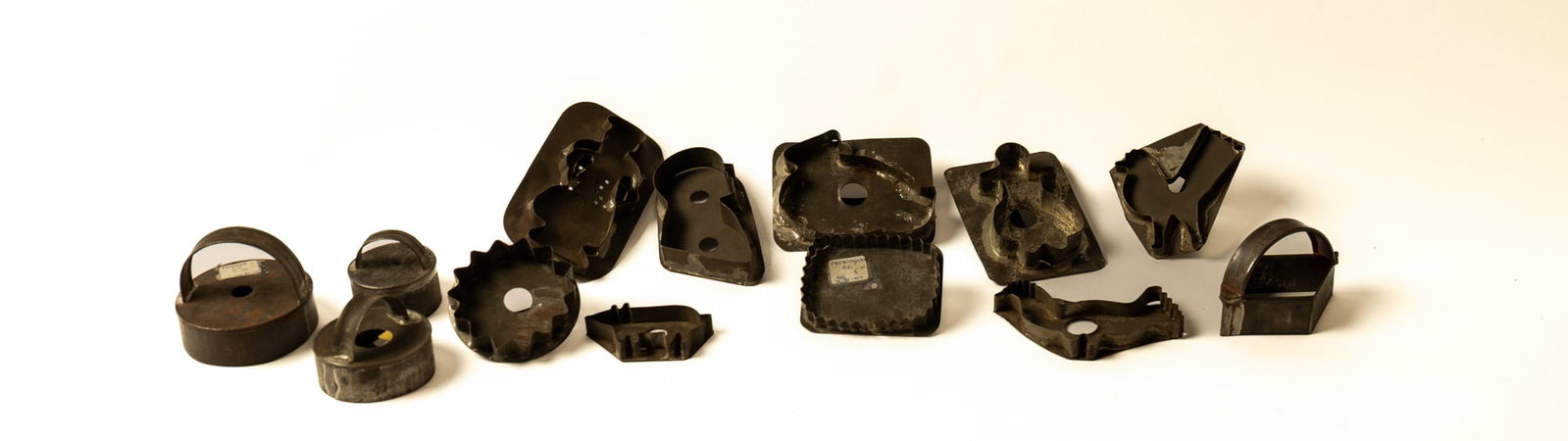 GROUP OF TINSMITH-MADE FIGURAL COOKIE CUTTERS.: GROUP OF TINSMITH-MADE FIGURAL COOKIE CUTTERS. American, early 20th Century. Includes three circular cutters, a diamond, a starburst, rectangular with pinked edge, a chick, two birds, a pig, a
