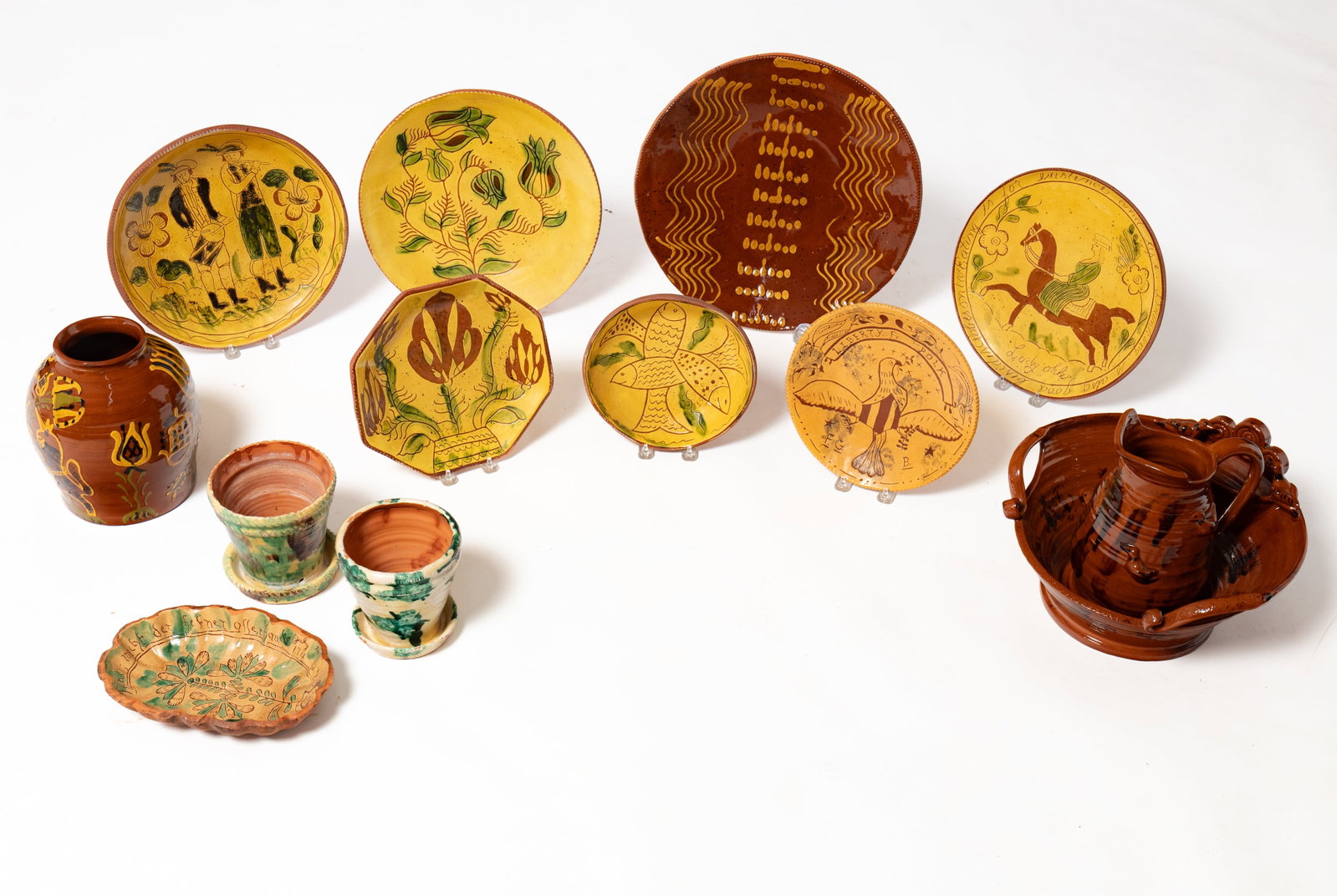 TWELVE REDWARE ITEMS IN THE 18TH AND 19TH CENTURY STYLE.: TWELVE REDWARE ITEMS IN THE 18TH AND 19TH CENTURY STYLE. American, late 20th Century. Eight are Breininger including a wash bowl and pitcher with high glaze and manganese sponging, a bowl with