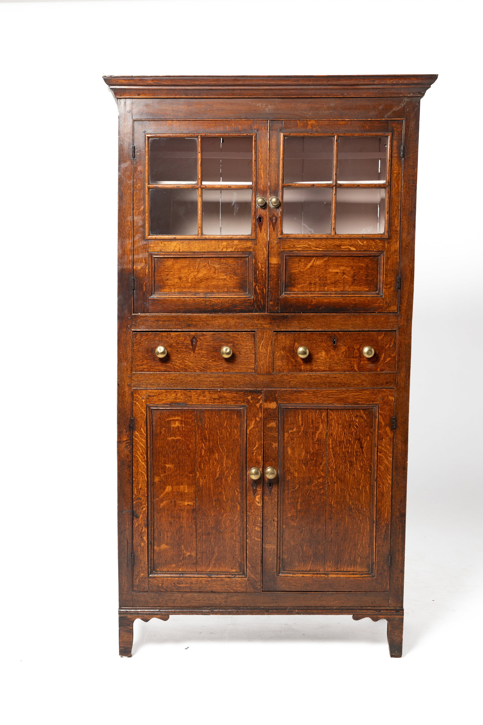 FLAT WALL CUPBOARD.: FLAT WALL CUPBOARD. English, first half 19th Century. Oak. Molded cornice, end with three panels, upper doors with four panes of glass and lower panel, two dovetailed drawers at waist, two lower