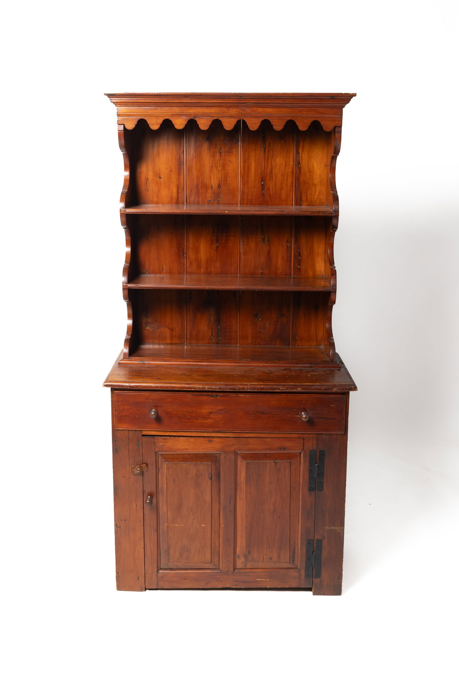 STEPBACK OPEN PEWTER CUPBOARD.: STEPBACK OPEN PEWTER CUPBOARD. American, first half 19th Century. Pine. Top with molded cornice, deeply shaped ends, and shelves with plate grooves. Base with overlapping dovetail drawer, lower