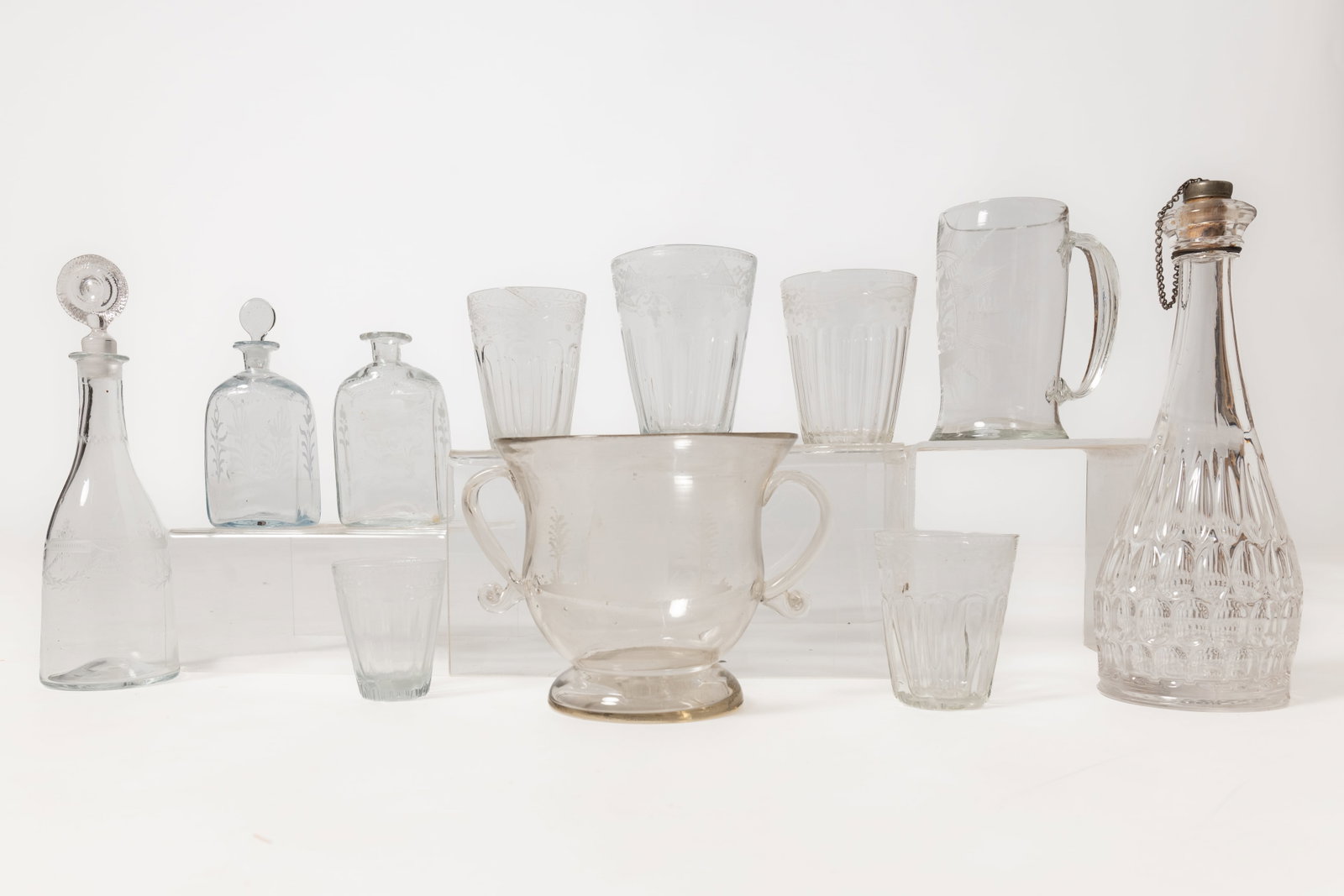 ELEVEN EARLY BLOWN GLASS ITEMS.: ELEVEN EARLY BLOWN GLASS ITEMS. American and English, late 18th and first half 19th Century. Five flip glasses with ribbed bodies, etched rims, and broken pontils; from 5''h. to 3.25''h. Two