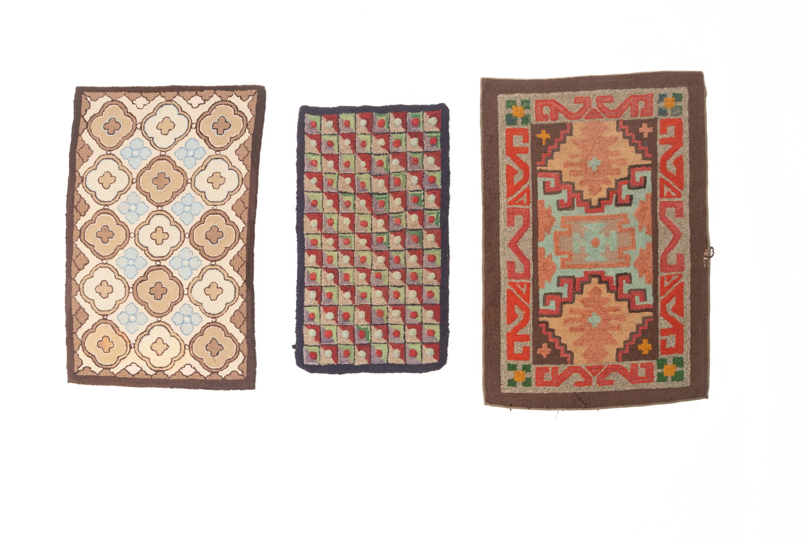 THREE YARN SEWN HOOKED AREA RUGS.: THREE YARN SEWN HOOKED AREA RUGS. American, early 20th Century. The largest with a Native American design in vibrant colors with a brown border, 28.5"w. 43.5"l. A hooked rug with a tan field filled