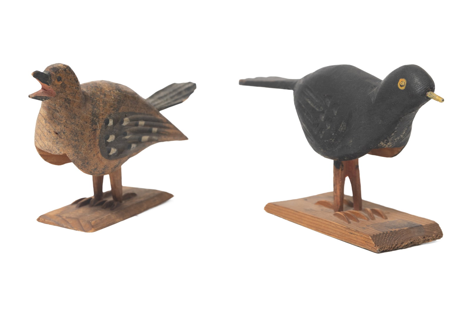 TWO FOLK ART CARVED AND PAINTED BOBBING WOODEN BIRDS.: TWO FOLK ART CARVED AND PAINTED BOBBING WOODEN BIRDS. American, 20th Century. Both have rectangular bases with feet, standing on two legs with bodies that bob. One in dark grey or black paint with a y
