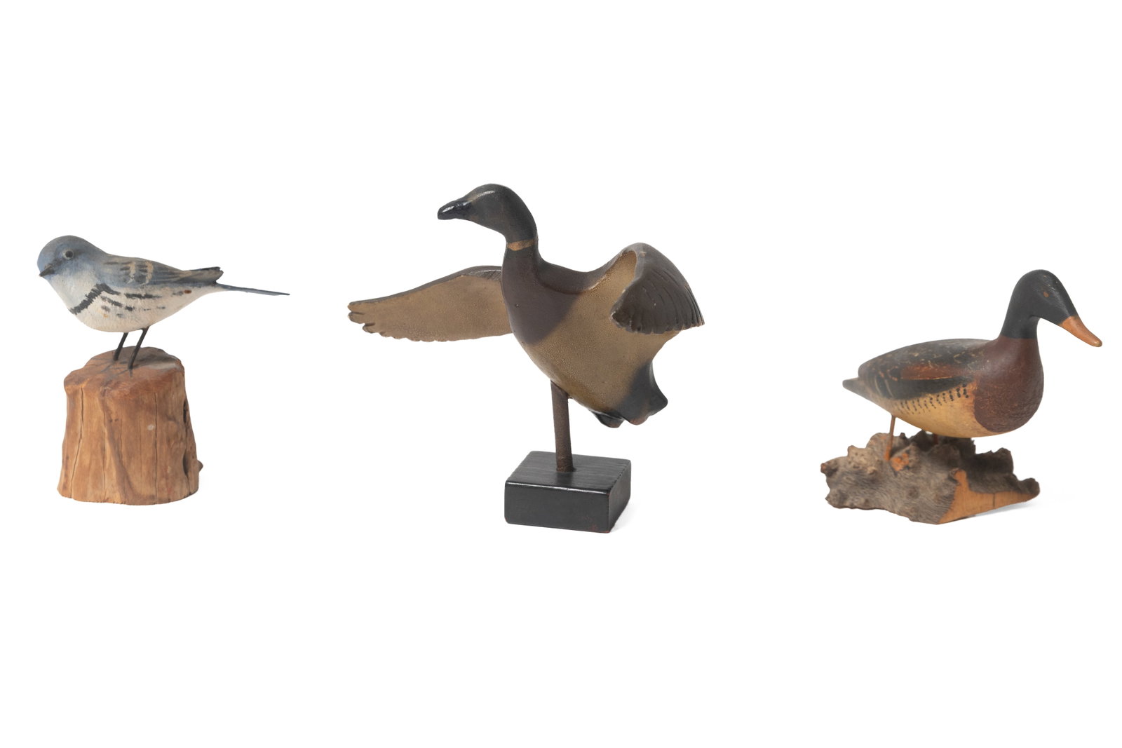 THREE DIMINUTIVE CARVED AND PAINTED BIRDS, INCL. PETER PELTZ (1915-2001).: THREE DIMINUTIVE CARVED AND PAINTED BIRDS, INCL. PETER PELTZ (1915-2001). American, 20th Century. The largest, a mallard in flight with spread wings on a black-painted base, 5.25"h., a carved and