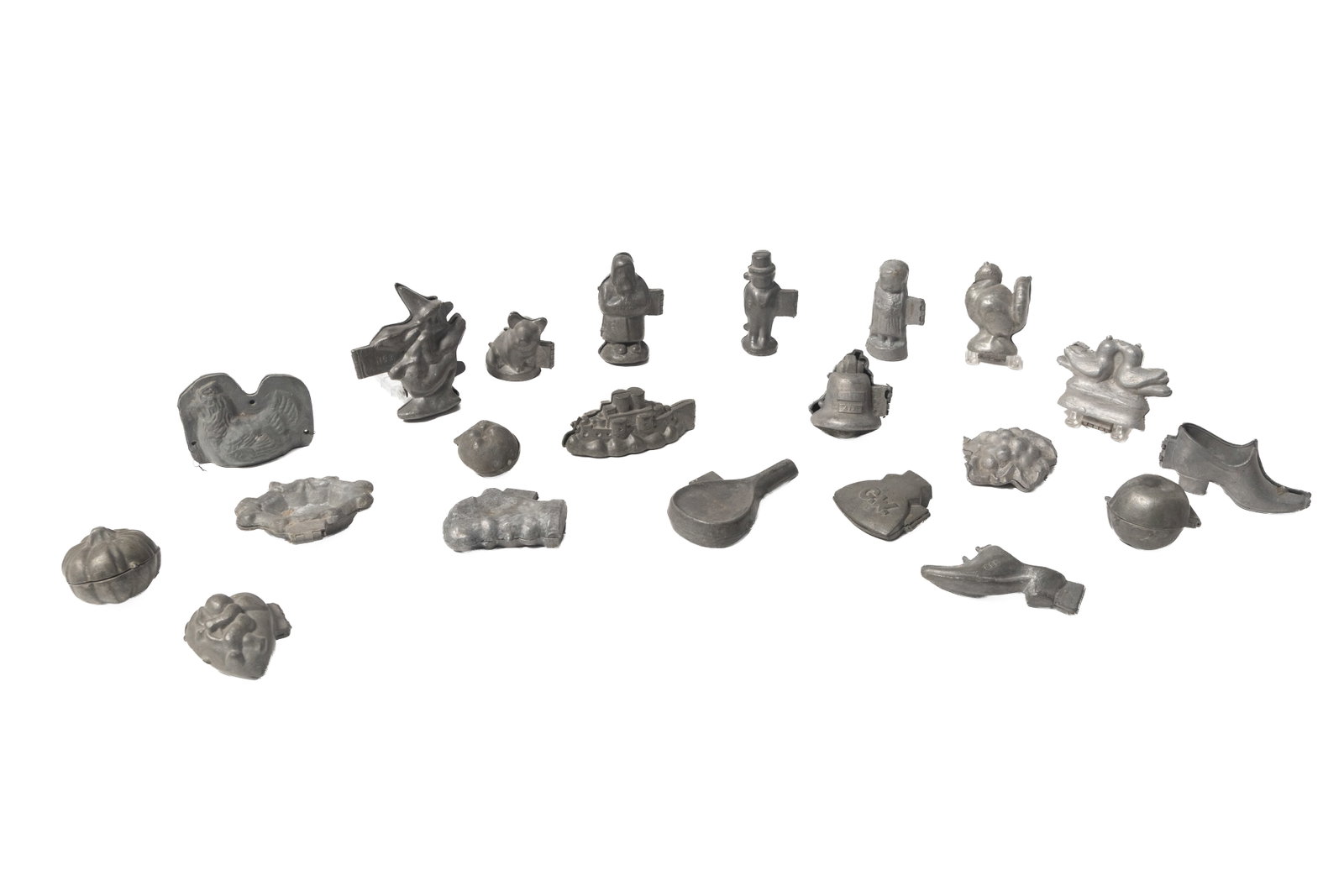 GROUP OF PEWTER CHOCOLATE OR ICE CREAM MOLDS.: GROUP OF PEWTER CHOCOLATE OR ICE CREAM MOLDS. American, 19th Century. Includes molds of a ship, fruits, people, shoes, a pig, birds, a witch, and others. Largest, 6"w.