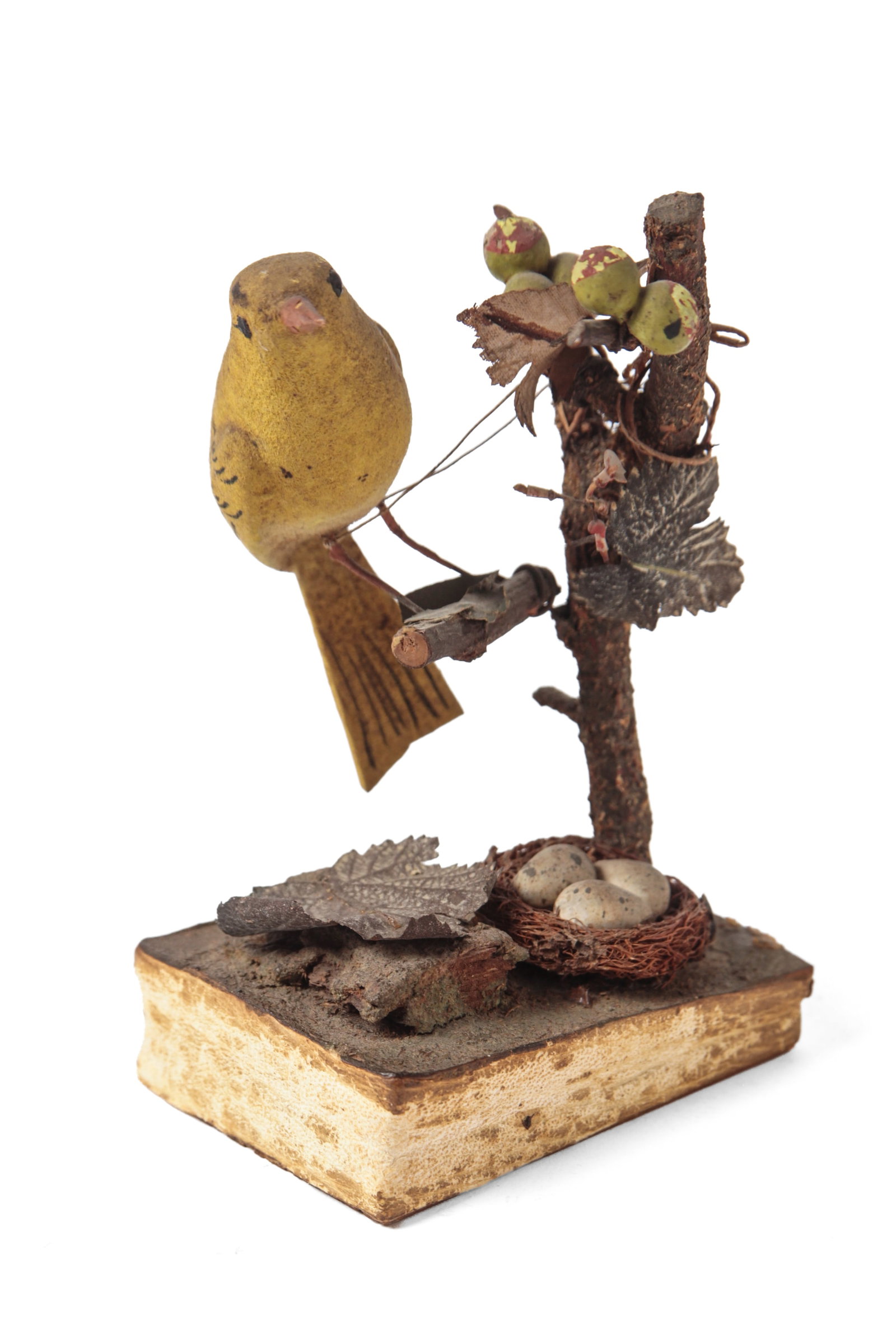 PAINTED BIRD IN TREE PIPSQUEAK.: PAINTED BIRD IN TREE PIPSQUEAK. German, early 20th Century. A yellow canary seated in a tree, with berry vines, embossed cloth leaves, and a nest sitting at the base of the tree. 5.5"h. 3.5"w.