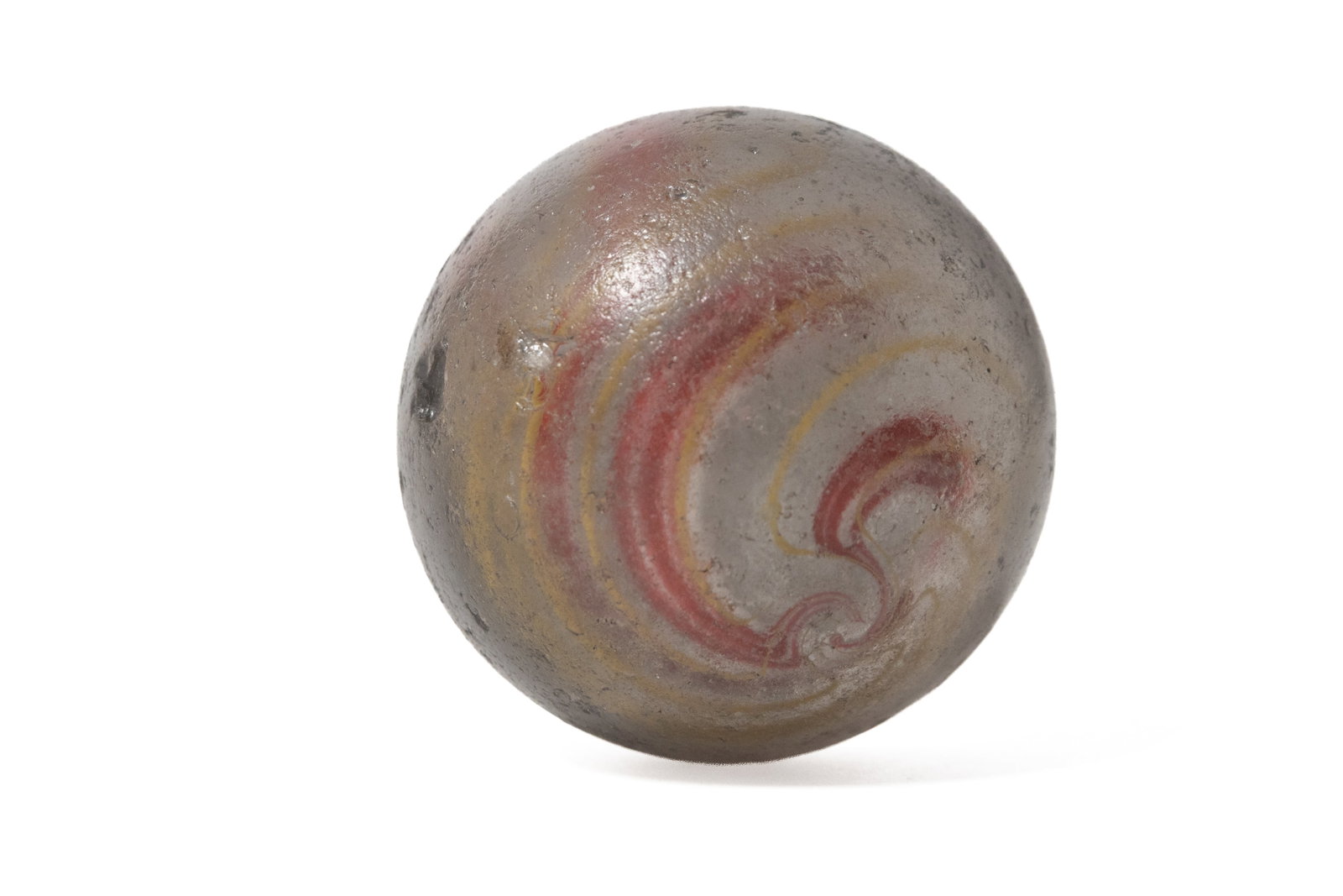LARGE LATTICINO CORE SWIRL GLASS MARBLE.: LARGE LATTICINO CORE SWIRL GLASS MARBLE. American or German, late 19th Century. Large handmade marble with white core and white and red, and yellow swirls. Approximately 1.75"d. Provenance: From the