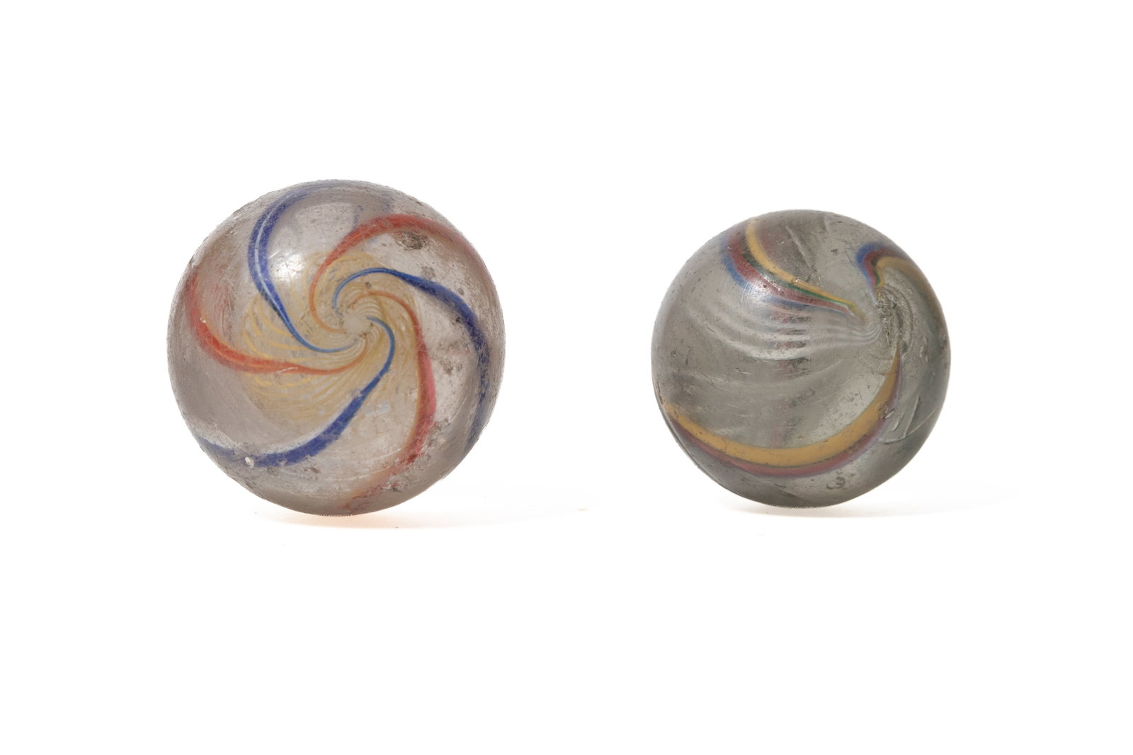 TWO LATTICINO CORE SWIRL GLASS MARBLES. (1 of 3)
