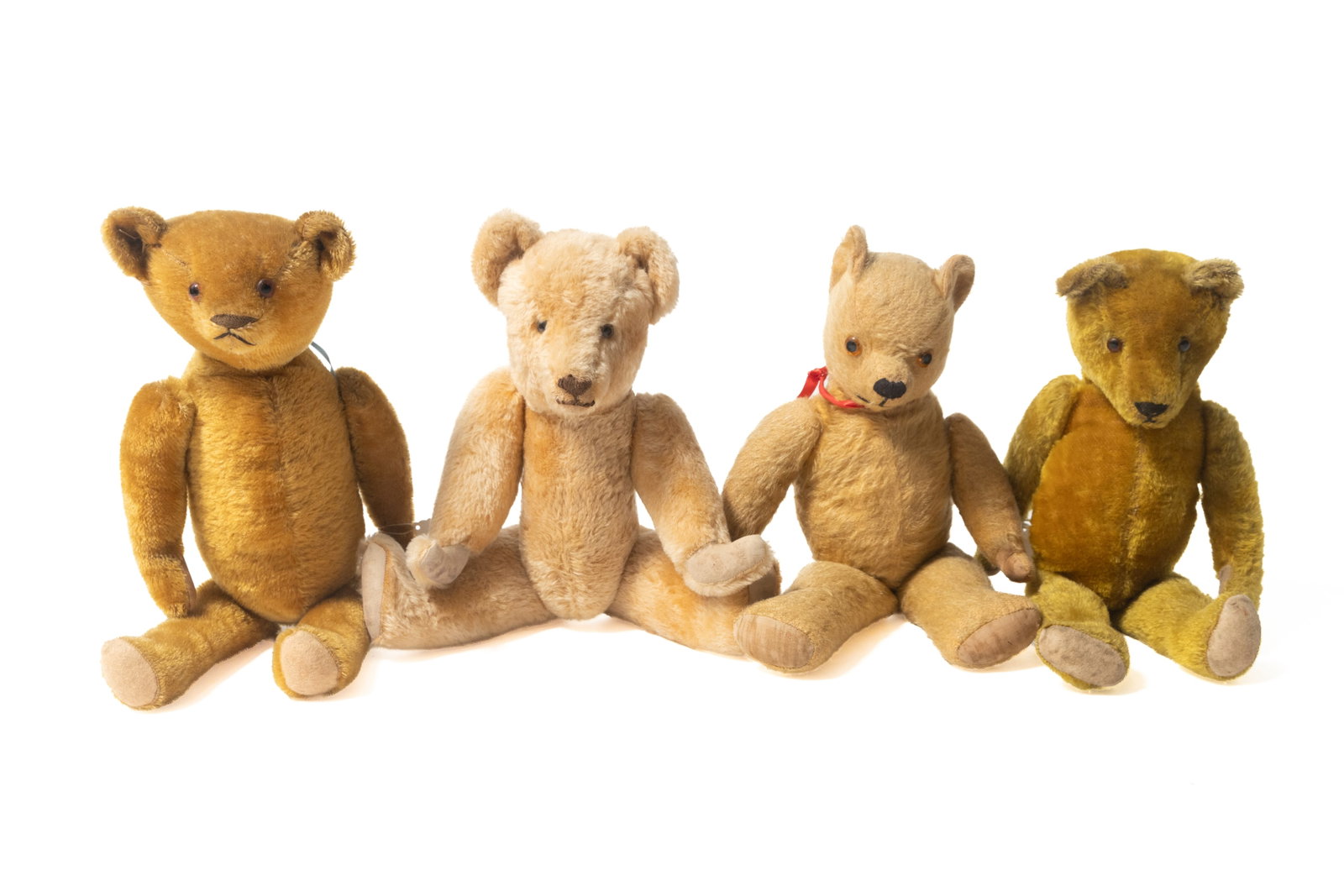 FOUR FULLY-JOINTED MOHAIR TEDDY BEARS.: FOUR FULLY-JOINTED MOHAIR TEDDY BEARS. German, early 20th Century. All straw-stuffed, with glass eyes, sewn mouths and with worn pads. From 21"h. to 18"h. Provenance: Nancy Goff (Alliance, Ohio).