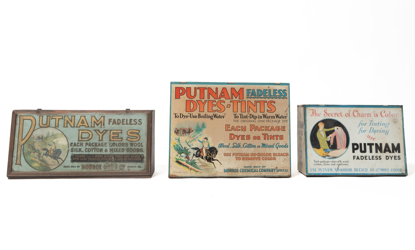 THREE COUNTERTOP PUTNAM DYE CABINETS.: THREE COUNTERTOP PUTNAM DYE CABINETS. American, 20th Century. One with a wooden, dovetailed case, painted, slanted lift lid, and paper lithograph to back, 10.25"h. 21"w. One made from a wooden case,