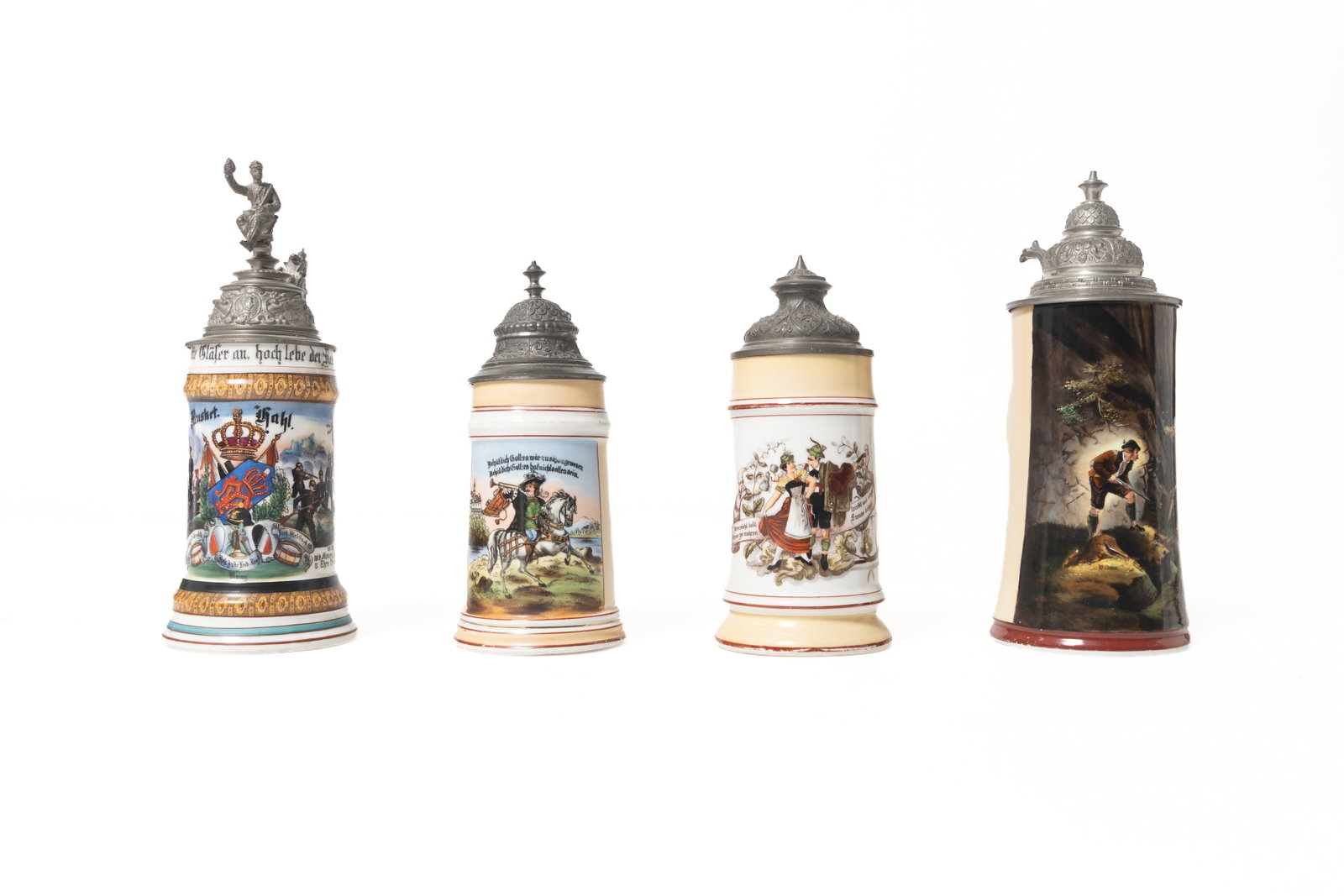 FOUR BEER STEINS WITH LITHOPHANE BOTTOMS.: FOUR BEER STEINS WITH LITHOPHANE BOTTOMS. German, late 19th and 20th Century. Porcelain. One is a regimental stein dated 1899, 11.25"h., the remaining three with transfer and painted scenes. From