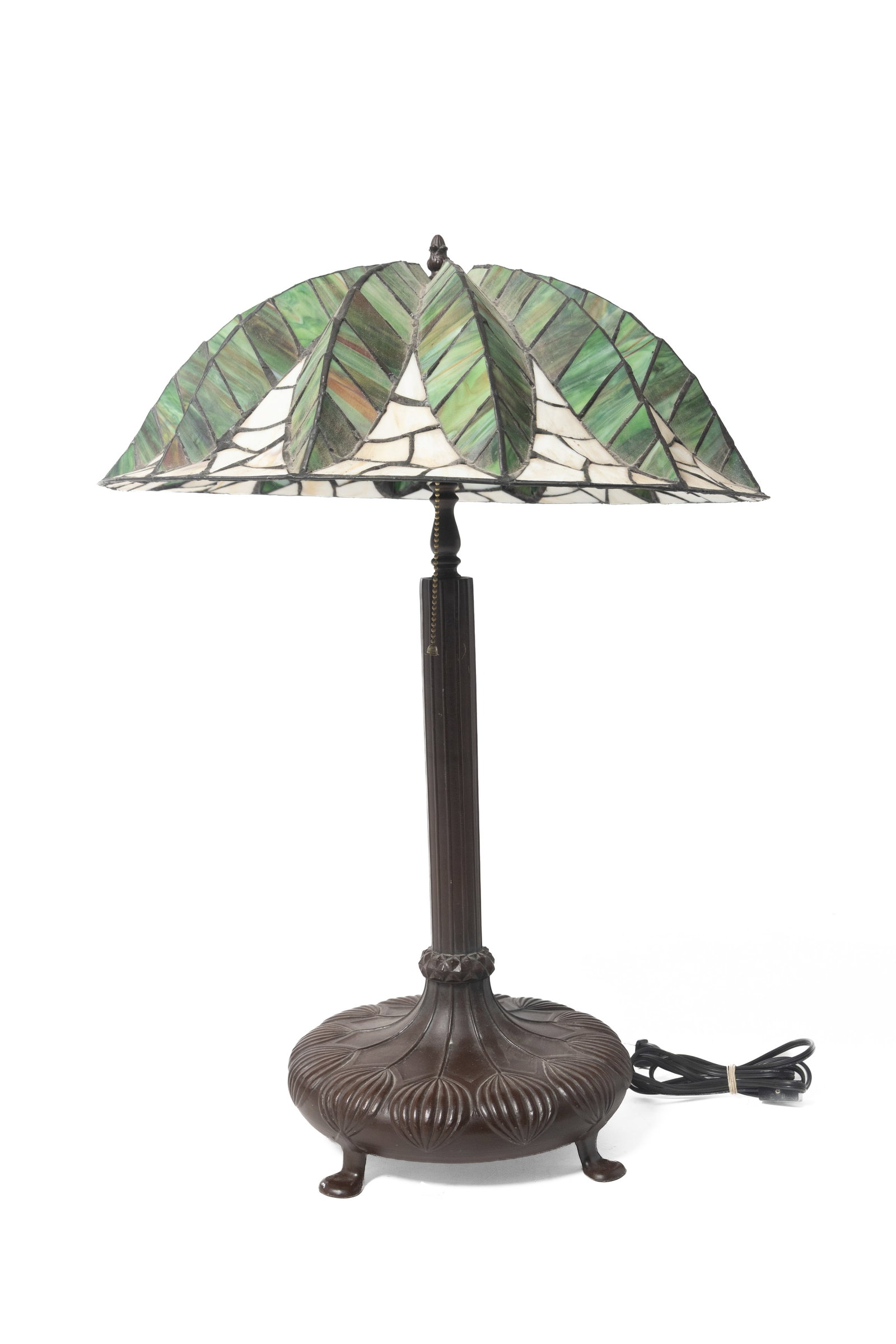 STAINED GLASS TABLE LAMP.: STAINED GLASS TABLE LAMP. Late 20th Century. Shade in green and light caramel slag, raised palm leaf design, and cast white metal, stylized floral pattern, double-socket fixture, and patinized